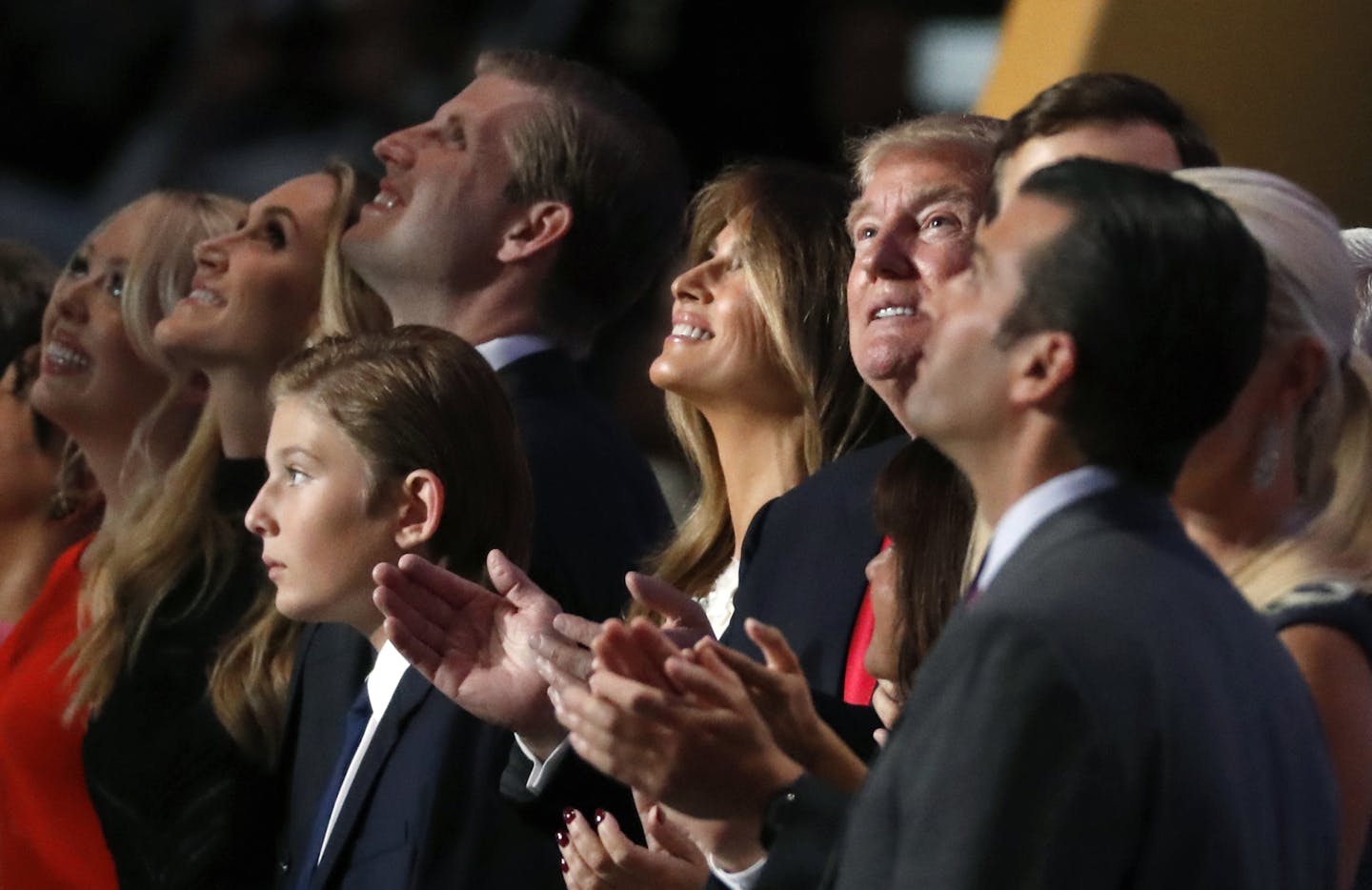 Visible left to right: Tiffany Trump, Lara Yunaska,, Eric Trump, Barron Trump, Melania Trump, Donald Trump and Donald Trump Jr. watch balloons and confetti fall during celebrations following Donald Trump's acceptance speech on the final day of the Republican National Convention in Cleveland, Thursday, July 21, 2016. (AP Photo/Paul Sancya)