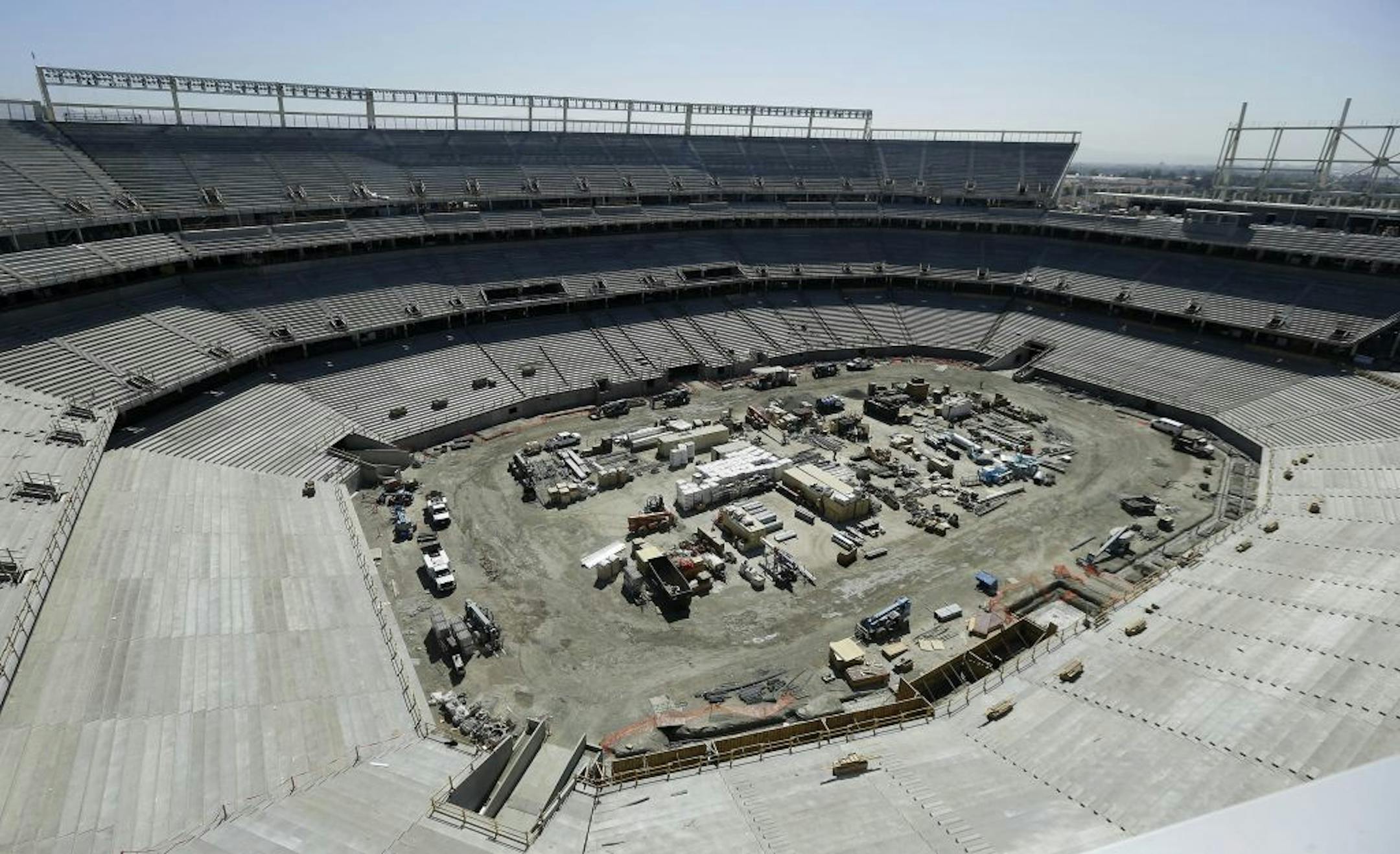 In this May 24, 2013 photo, construction for the new San Francisco 49ers football stadium is shown in Santa Clara, Calif., Friday, May 24, 2013. Goodbye grungy, cold Candlestick Park. Hello high tech, glittering, Levi's Stadium. Fifty-four years after $32 million Candlestick Park opened, the 49ers are building a new $1.2 billion showcase of a stadium which is almost twice as big, wired to the hilt, and opening its doors just in time to host Superbowl 50 in the heart of the Silicon Valley.