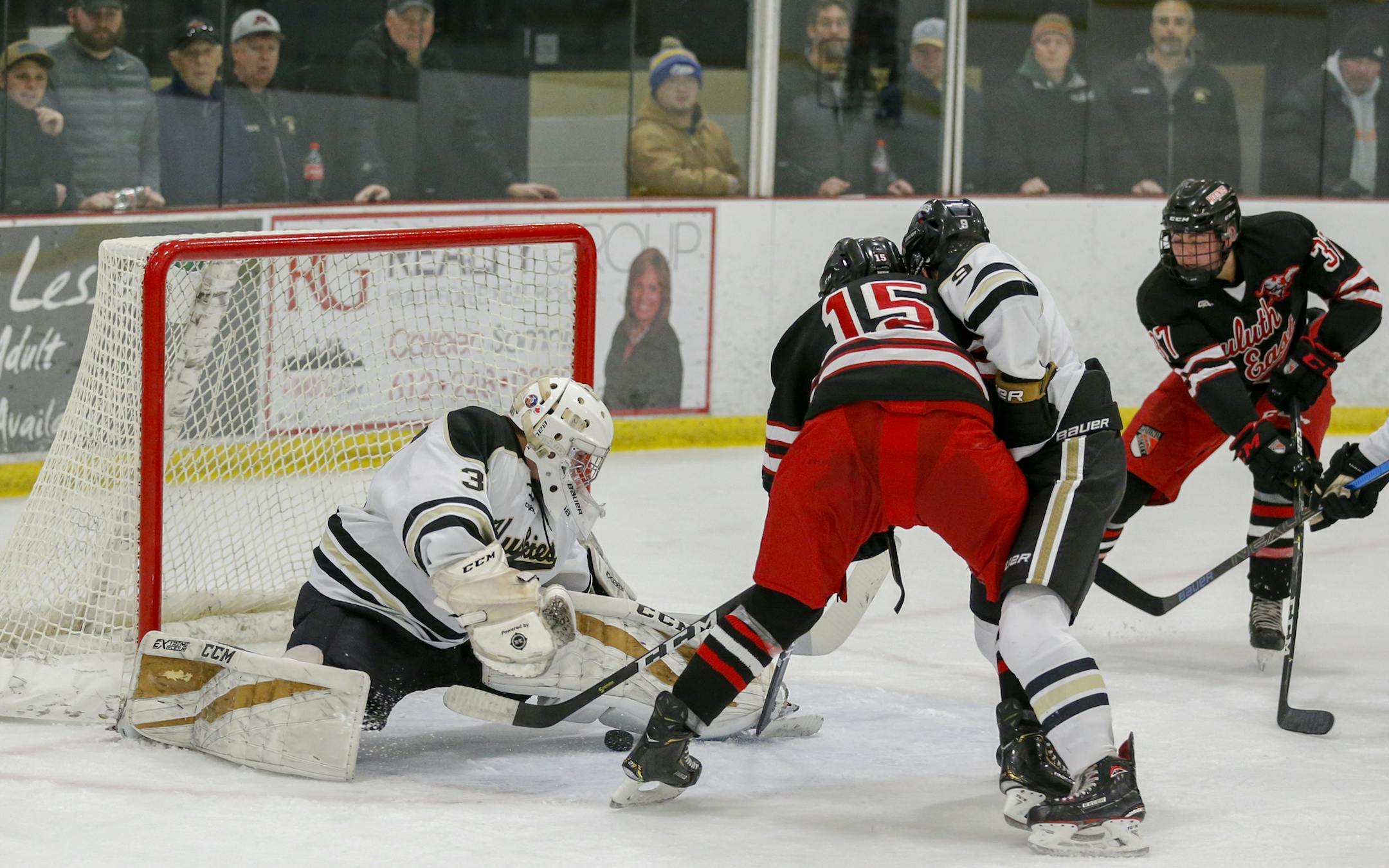 Andover's Ben Fritsinger stretches to make a second period save against Duluth East. Fritsinger had 35 saves in the Huskies' 2-1 overtime victory over the Greyhounds on Dec. 8, 2018. Photo by Jeff Lawler, SportsEngine