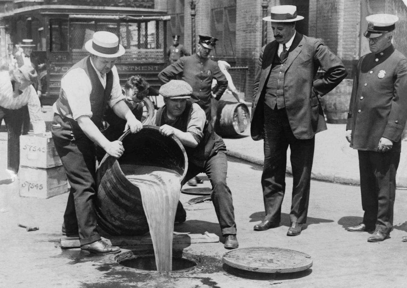 An undated handout photo of New York City police official watching agents pour liquor into a sewer following a raid during the Prohibition era, around 1921. The new PBS documentary "Prohibition" explores the roots of the 18th Amendment banning alcohol sales, wedge-issue politics and legislating morality. (Library of Congress, Prints & Photographs Division via The New York Times) -- EDITORIAL USE ONLY. -- PHOTO MOVED IN ADVANCE AND NOT FOR USE - ONLINE OR IN PRINT - BEFORE SEPT. 25, 2011. ORG XMI