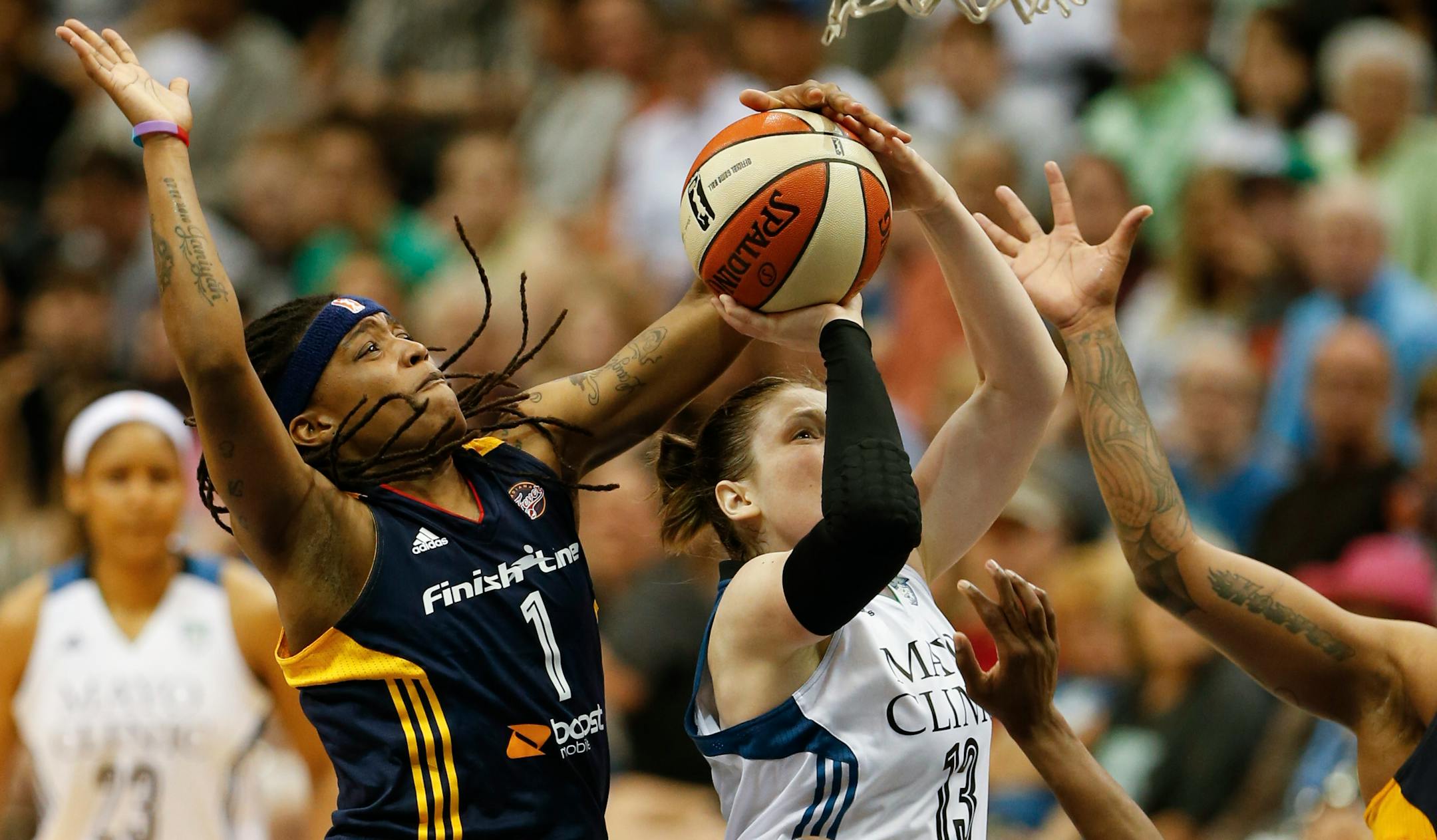 Lynx guard Lindsay Whalen (13) was fouled by Indiana's Shavonte Zellous (1) on her way to the hoop in the second quarter at Target Center Sunday evening.