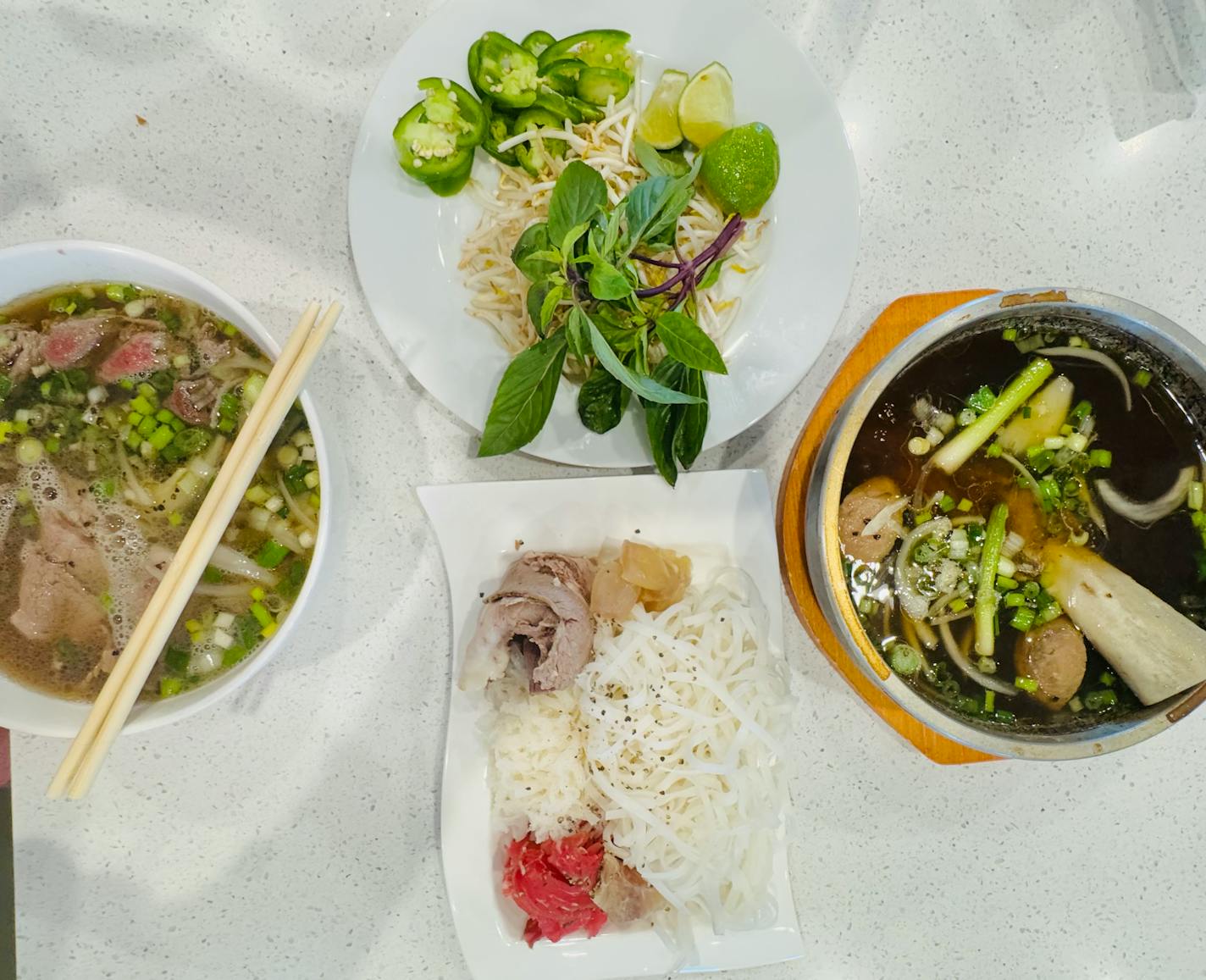 The new Stone Pho features traditional beef pho (left) along with stone pho, in which you add noodles and cook meats tableside from a stone bowl filled with piping hot broth.