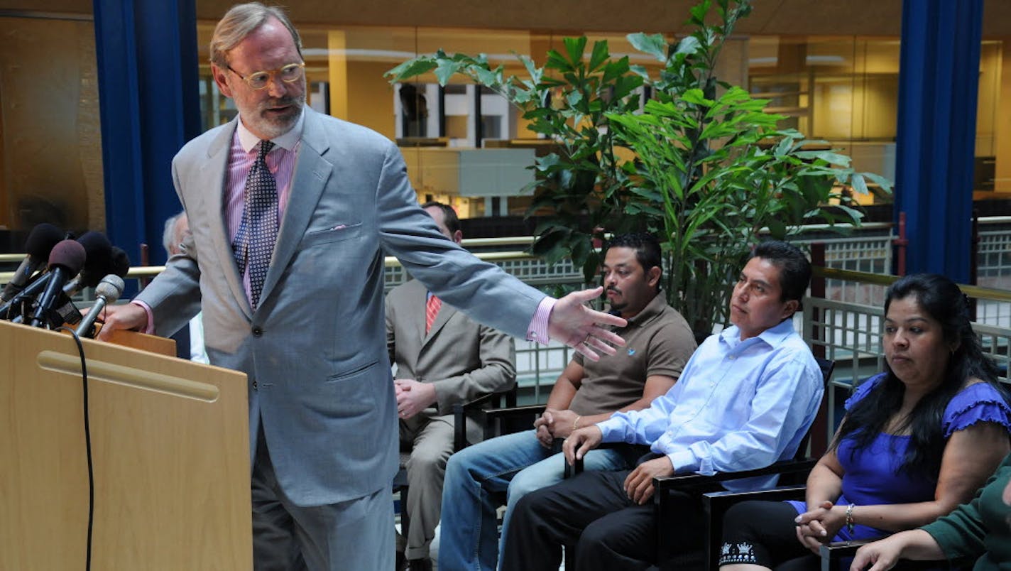 Randy Hopper, an attorney representing the victims of the Metro Gang Strike Force, announced a tentative settlement of $3 million in a federal law suit . Some of the victims are, from left: Dagoberto Rodriguez Cardona, Zenoldo Rivera Garcia and Maura Gonzalez.