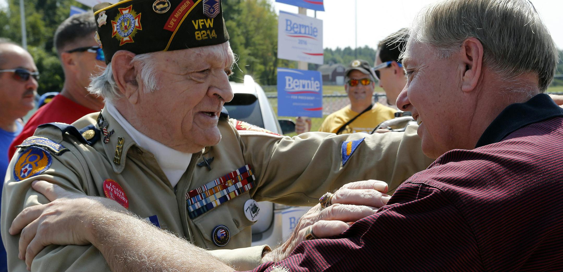 Republican presidential candidate Sen. Lindsey Graham, R-S.C., talks with Lionel Lablanc before marching in the Labor Day parade Monday, Sept. 7, 2015, in Milford, N.H. (AP Photo/Jim Cole)