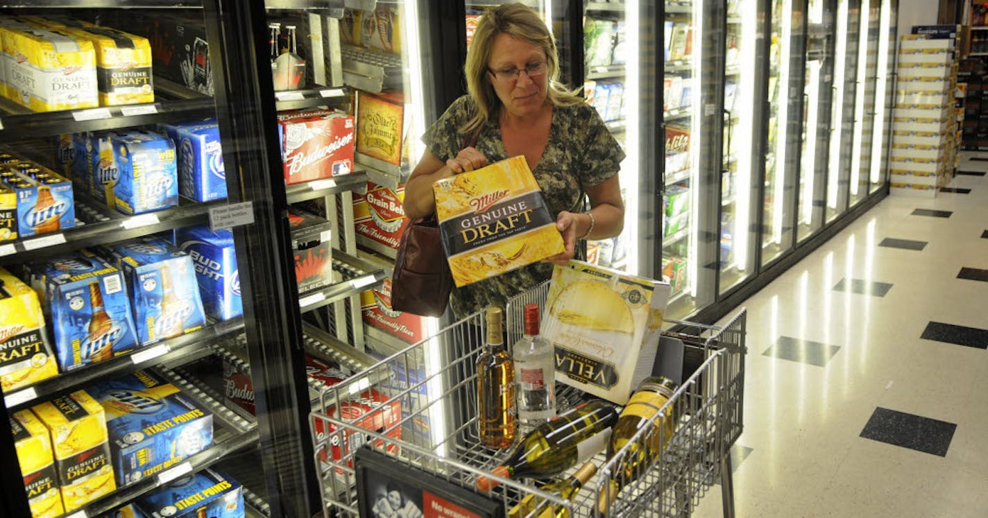 Diane O'Brien of New Brighton, Minn., grabbed a 12-pack of Miller Genuine Draft out of the cooler at Surdyk's In Minneapolis on Wednesday afternoon.