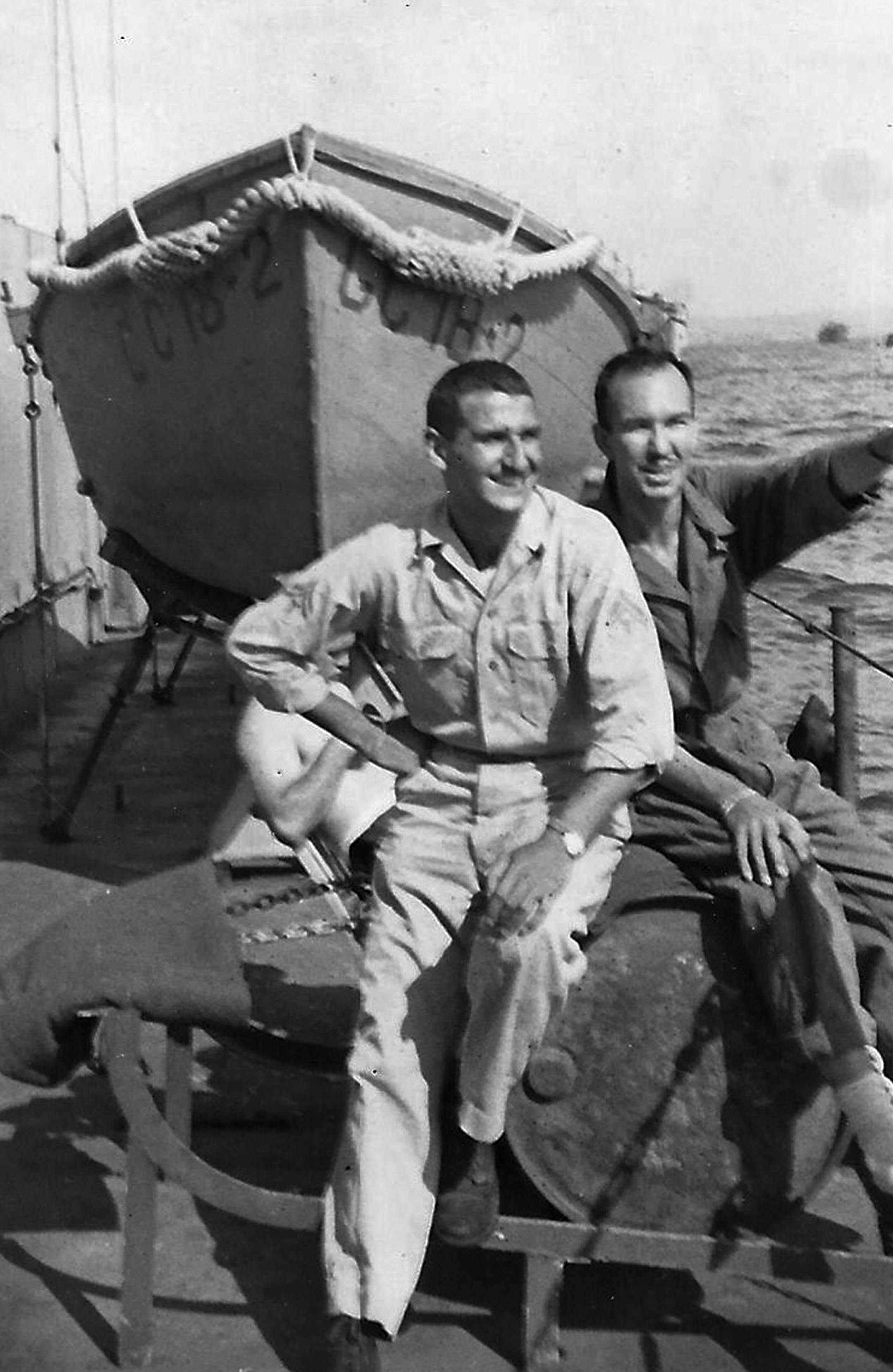 This World War II-era photo provided by the family shows Morton Tuller, left, on a ship with a friend. For decades, the cryptologist told no one, not even his wife, about his work on Navy ships that landed in Sicily, southern France, north Africa, Okinawa and Iwo Jima. (AP Photo)