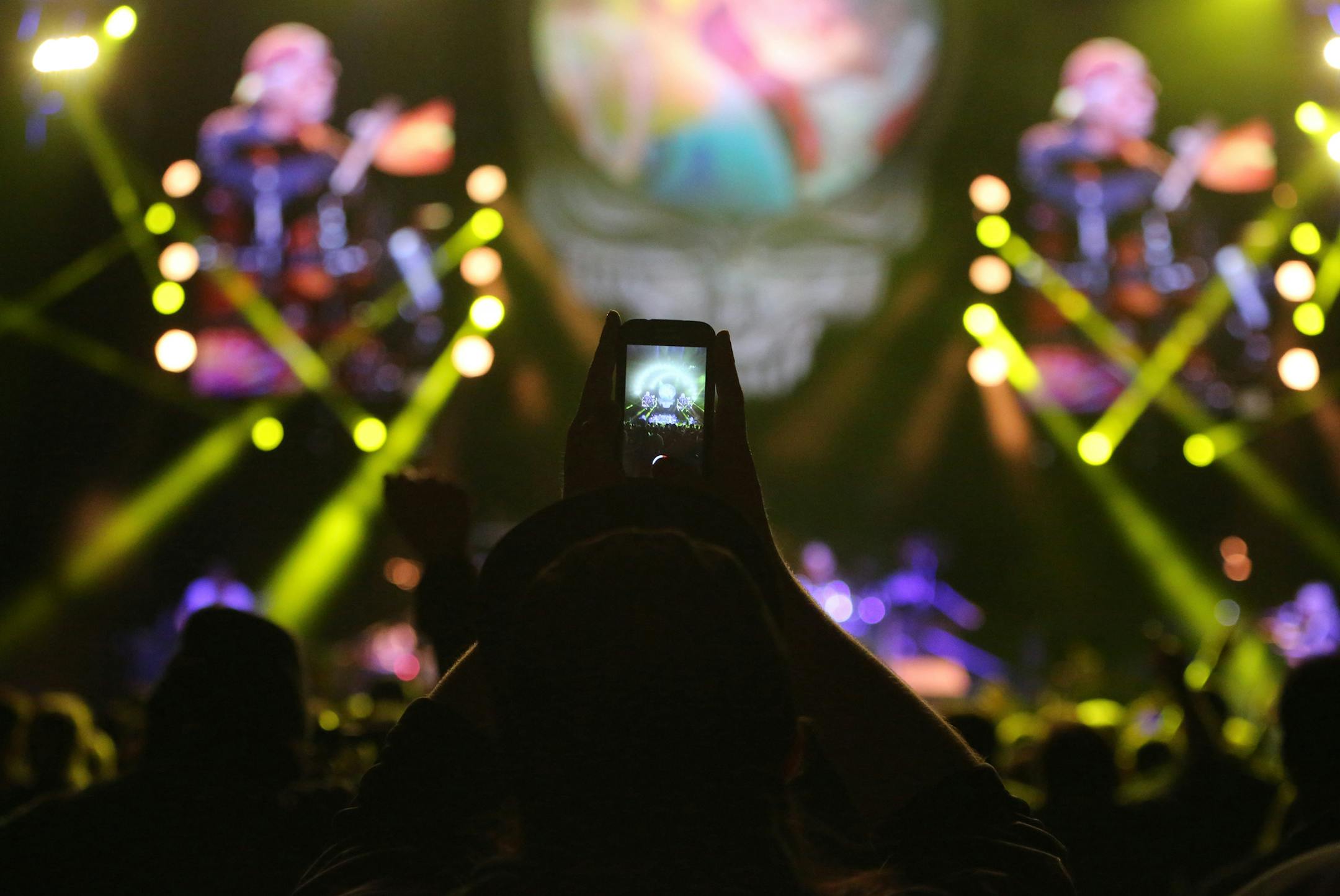 Dead & Company, new band featuring 3 members of Grateful Dead including Bob Weir and rock star John Mayer, in concert at Target Center on Saturday, Nov. 21, 2015, in Minneapolis, MN. Here, a fan takes a cell phone photo of the band performing.](DAVID JOLES/STARTRIBUNE)djoles@startribune.com Dead & Company, new band featuring 3 members of Grateful Dead and rock star John Mayer, in concert at Target Center on Saturday, Nov. 21, 2015, in Minneapolis, MN.