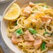A bowl of salmon pasta has bright flavors with zucchini noodles, snap peas and lemon cream sauce.