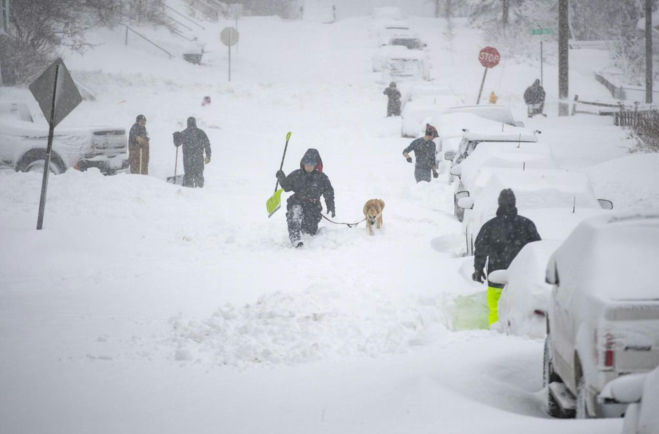 Neighbors worked together Sunday morning in an effort to clear out as much snow as possible from E. 8th St. in Duluth, MN .