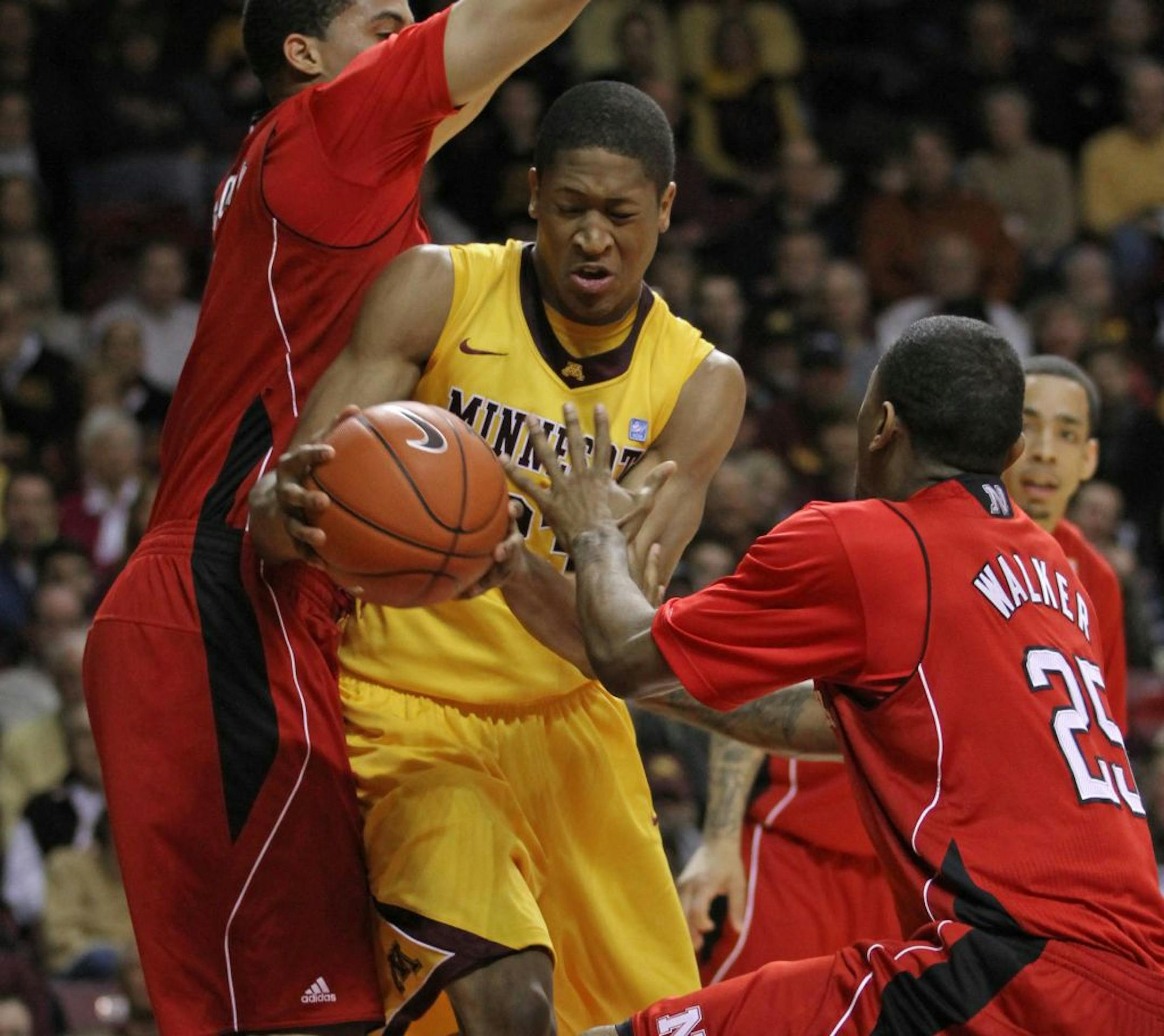 Minnesota Gophers Basketball vs Nebraska, 3/3/12, (center) Minnesota Gophers Rodney Williams drove to the basket as he was defended by Nebraska's (left) Toney McCray and (right) Caleb Walker in second half action.