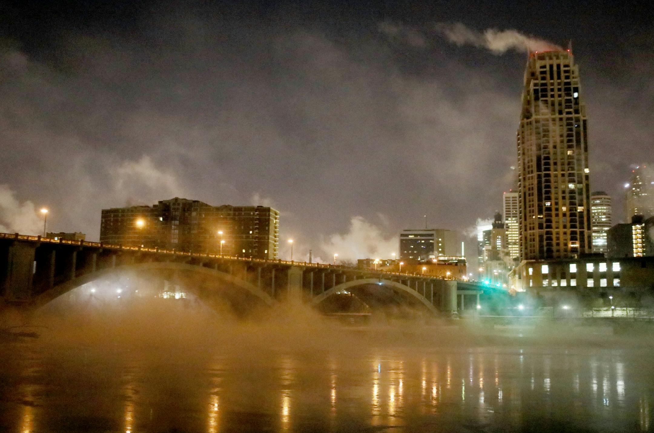 Seen from Nicollet Island vapor from the Mississippi River hangs above the water with downtown visible Wednesday, Jan. 30, 2019, In Minneapolis, MN.