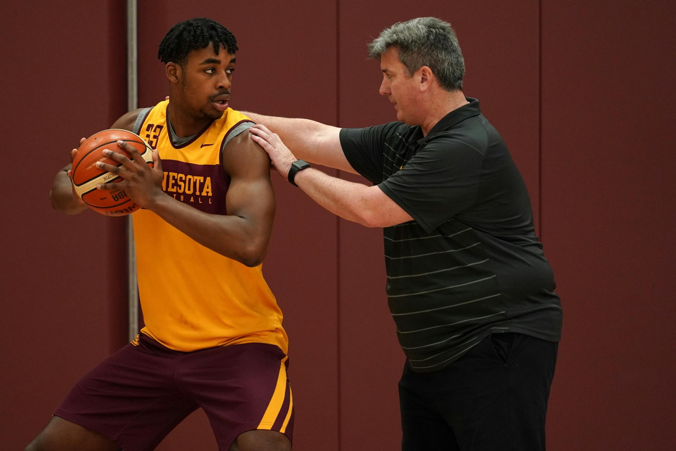 Gophers center Sam Freeman worked with assistant coach Ed Conroy during Thursday's practice.