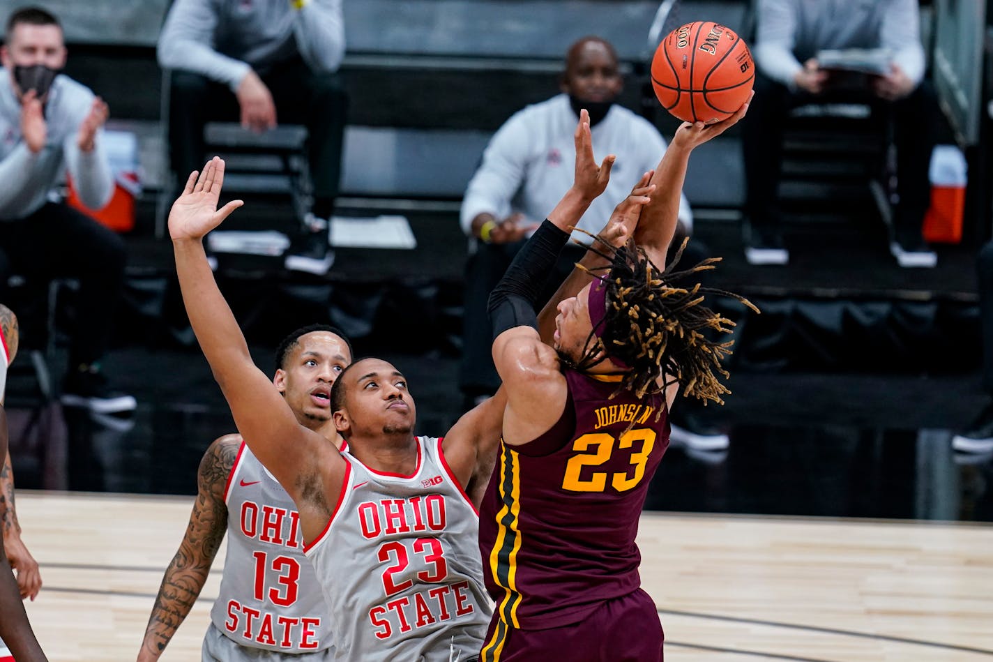 Minnesota forward Brandon Johnson (23) shoots over Ohio State forward Zed Key (23) in the first half of an NCAA college basketball game at the Big Ten Conference tournament in Indianapolis, Thursday, March 11, 2021. (AP Photo/Michael Conroy)