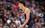 Michigan forward D.J. Wilson reacts during the first half of an NCAA college basketball game against Purdue in the Big Ten tournament, Friday, March 1