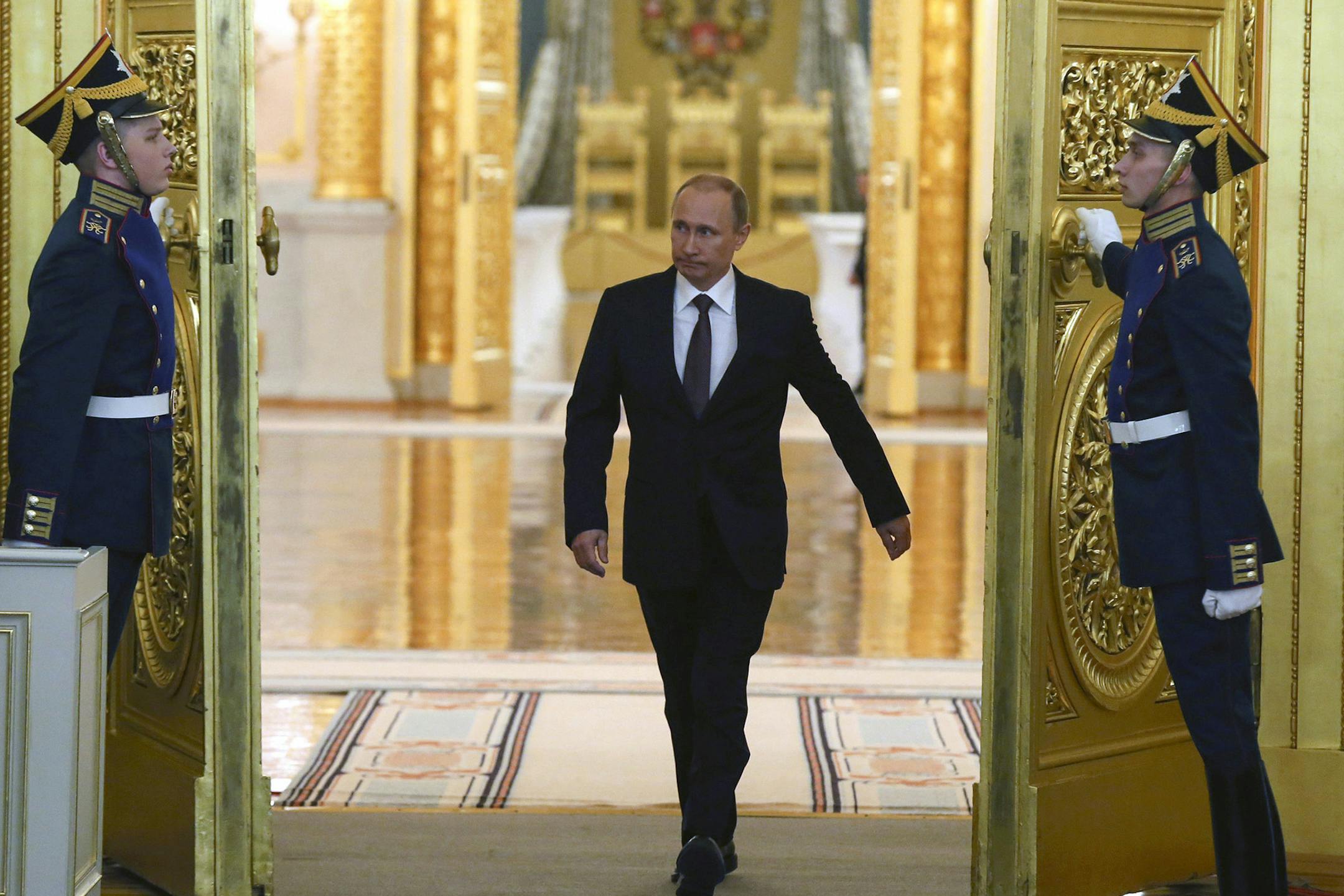 Russian President Vladimir Putin en route to address the Federal Assembly at the Kremlin in Moscow, March 18, 2014. Putin claimed Crimea as a part of Russia Tuesday and signed a draft treaty with Crimean leaders to make the strategic Black Sea peninsula part of the country. (Sergei Ilnitsky/Pool via The New York Times) -- FOR EDITORIAL USE ONLY. -- ORG XMIT: MIN2014032011510539