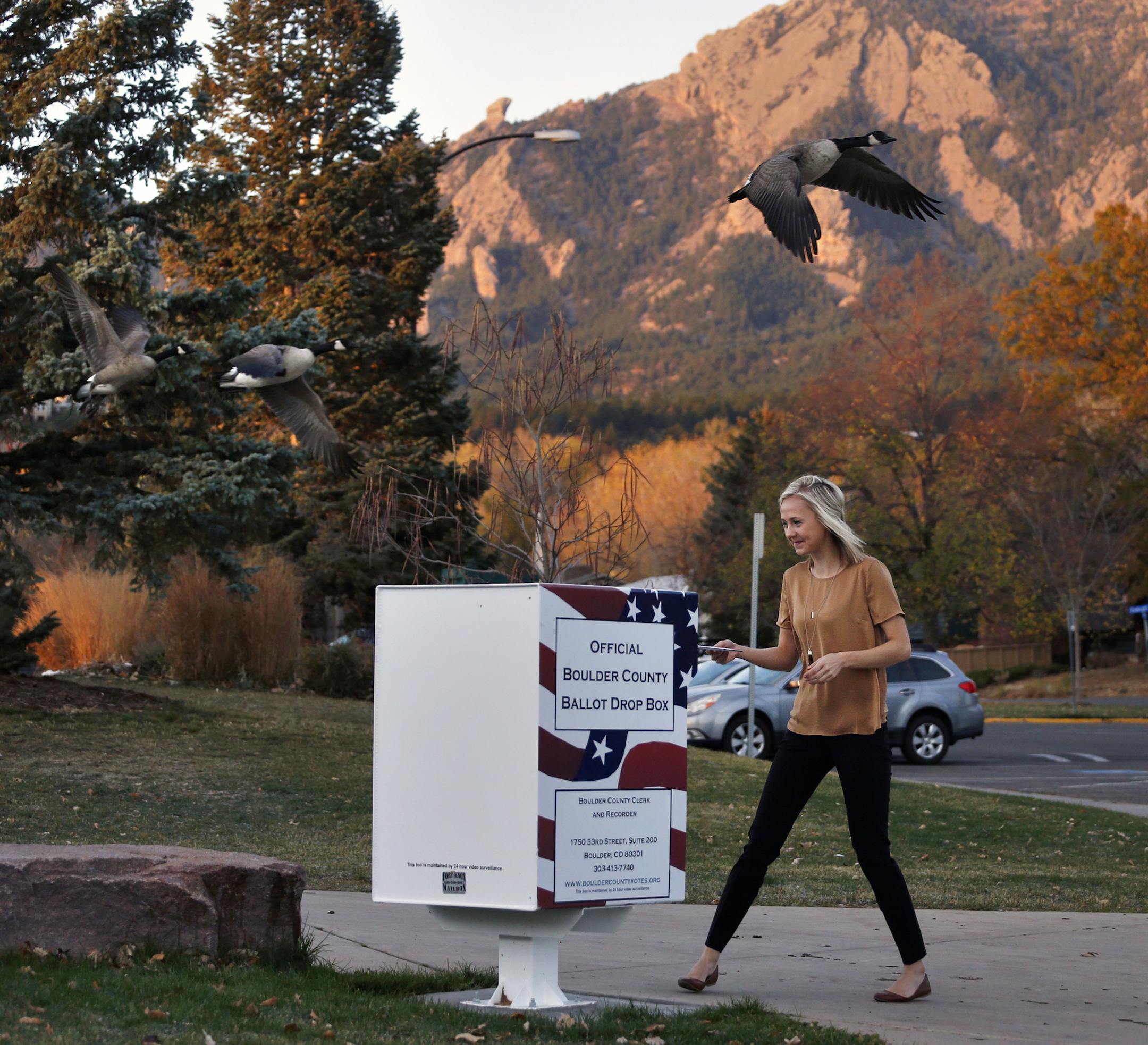 Emily Chatburn, who teaches 3rd grade at a local elementary school, puts her completed voter ballot into a drop box at a recreation center in Boulder, Colo., Tuesday, Nov. 8, 2016. Regarding the divisiveness in American politics, Chatburn says: "I try to get an understanding for both sides, where they are coming fromÖ I think that it will be very interesting to see what happens. And whatever president it is, they'll get settled, and I think, just really, I'm hoping that no matter who the pr