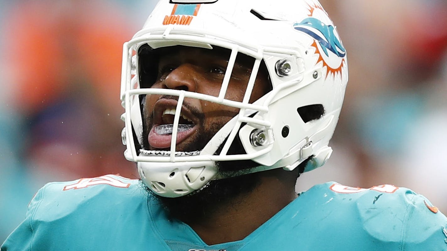 Miami Dolphins defensive tackle Christian Wilkins (94) celebrates after sacking Cincinnati Bengals quarterback Andy Dalton, during the second half at an NFL football game, Sunday, Dec. 22, 2019, in Miami Gardens, Fla. (AP Photo/Brynn Anderson)