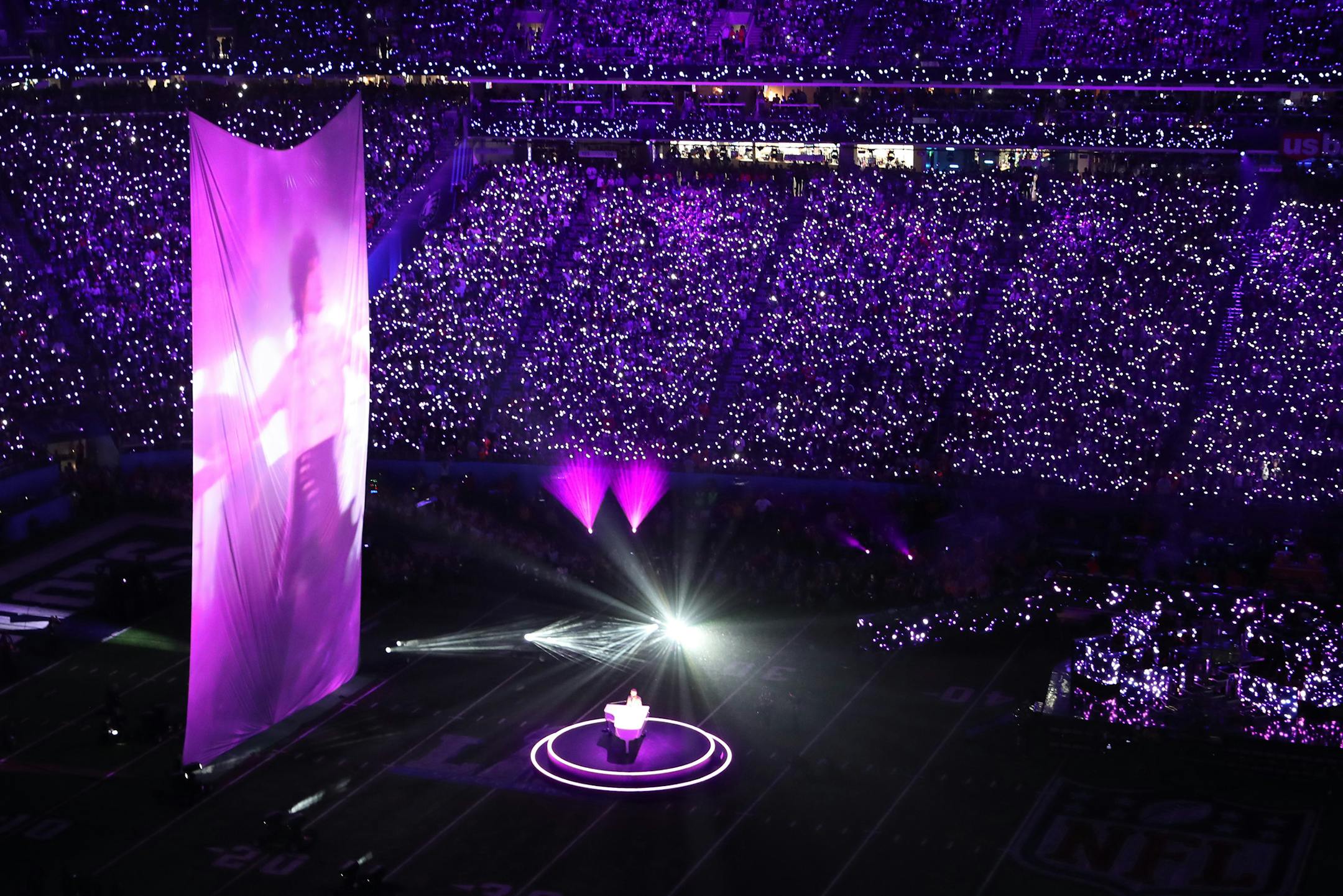 Justin Timberlake pays tribute to Prince, singing "I Would Die 4 U," as video of the music icon performing in "Purple Rain" is projected on a large screen during the Super Bowl halftime show.