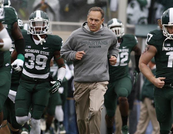 Michigan State coach Mark Dantonio, center, ran onto the field with the Spartans before playing against Michigan last November.
