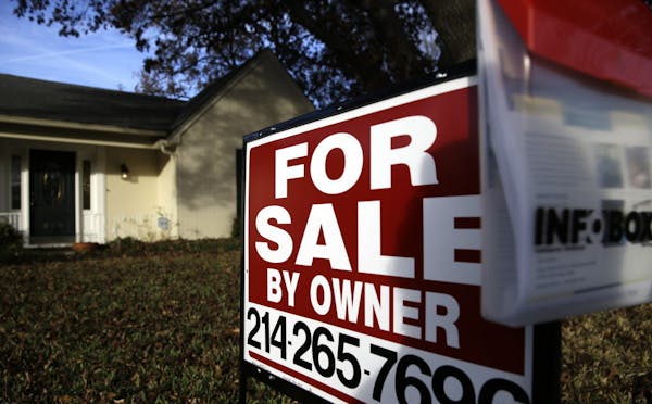 FILE - In this Dec. 16, 2014 file photo, a for sale by owner sign sits in front of a home in Richardson, Texas. Real estate data provider CoreLogic re