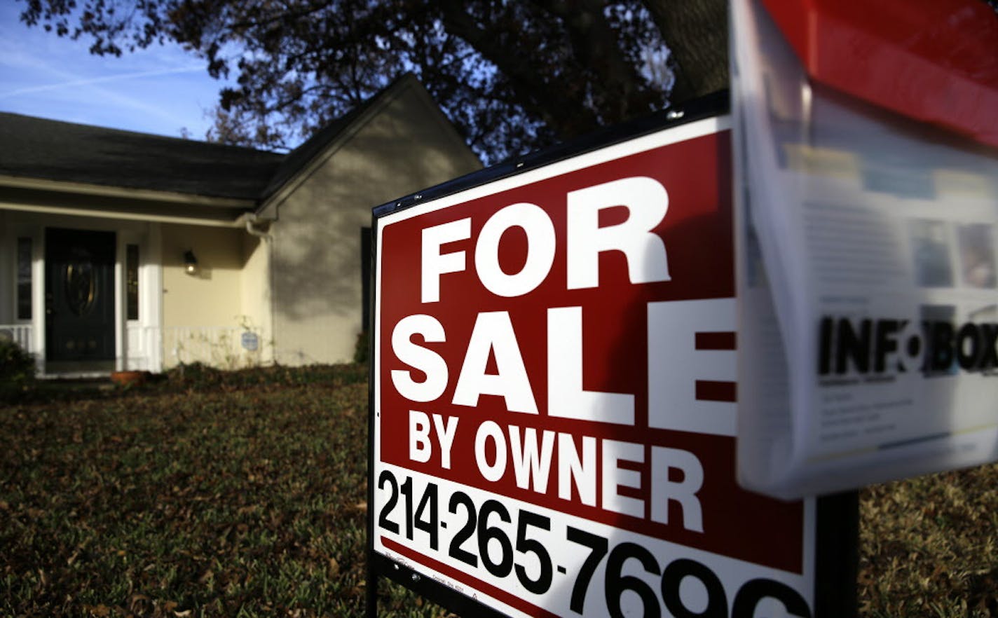 FILE - In this Dec. 16, 2014 file photo, a for sale by owner sign sits in front of a home in Richardson, Texas. Real estate data provider CoreLogic reports on November home prices on Tuesday, Jan. 6, 2015. (AP Photo/LM Otero, File) ORG XMIT: MIN2015010823474223