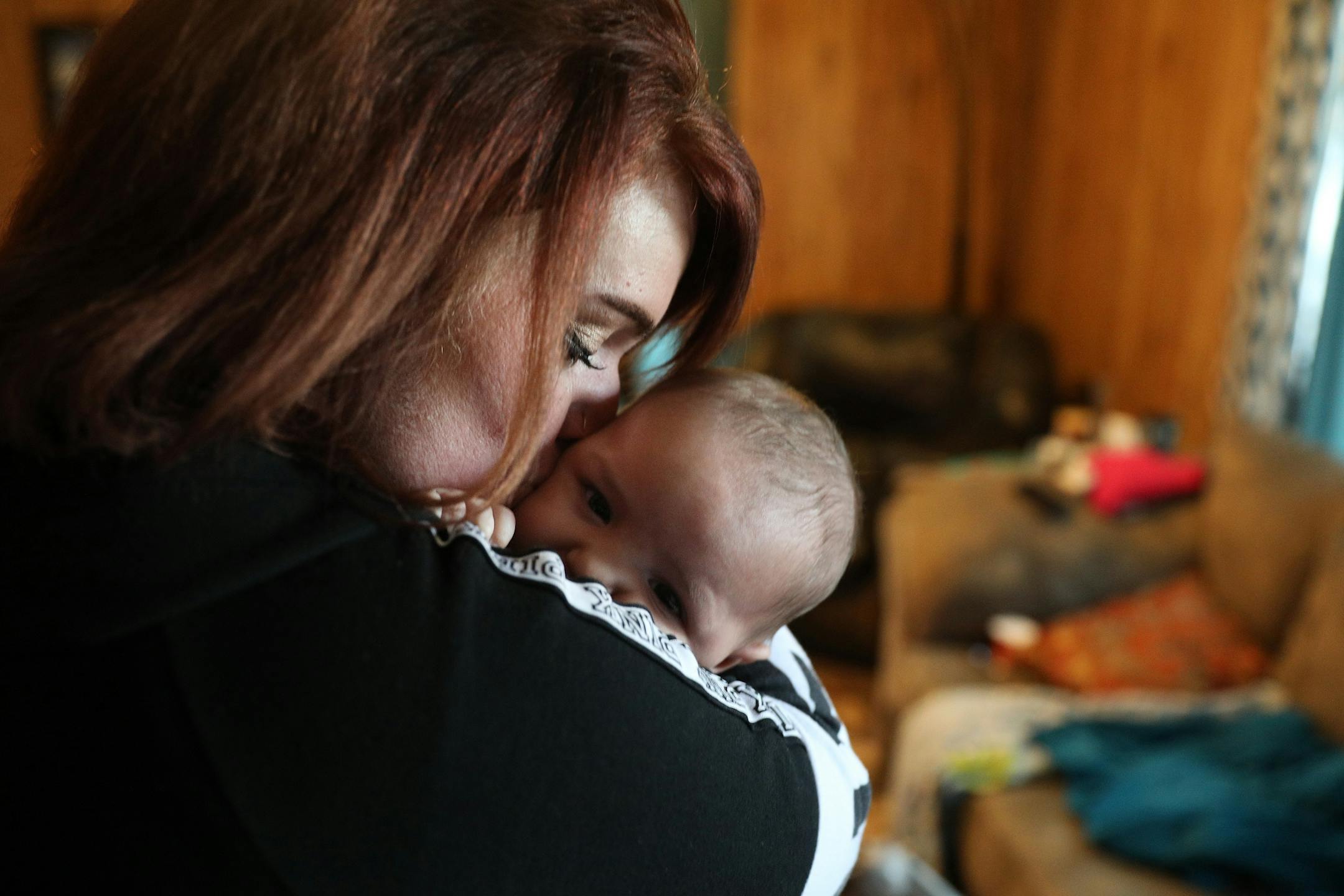Ashley Benson, a mother of four who went through Sanford Bemidji Medical Center's First Steps program to help pregnant opioid addicts wean off their addictions, gave a kiss to her son Graysen Burnette, 4-months, at their home.