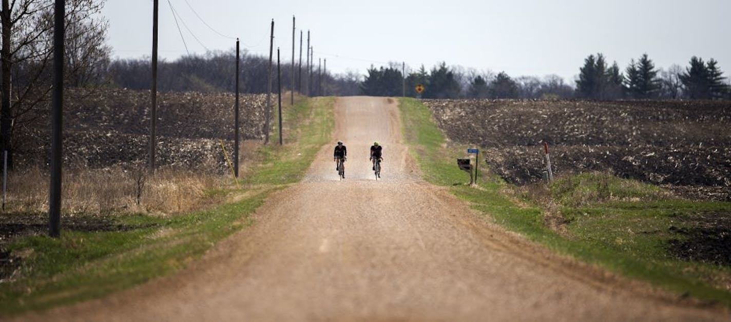 Sean Mailen and Ben Witt of Salsa Cycles ride gravel roads in a rural area in Colgate, Minn. on Friday, April 17, 2015.