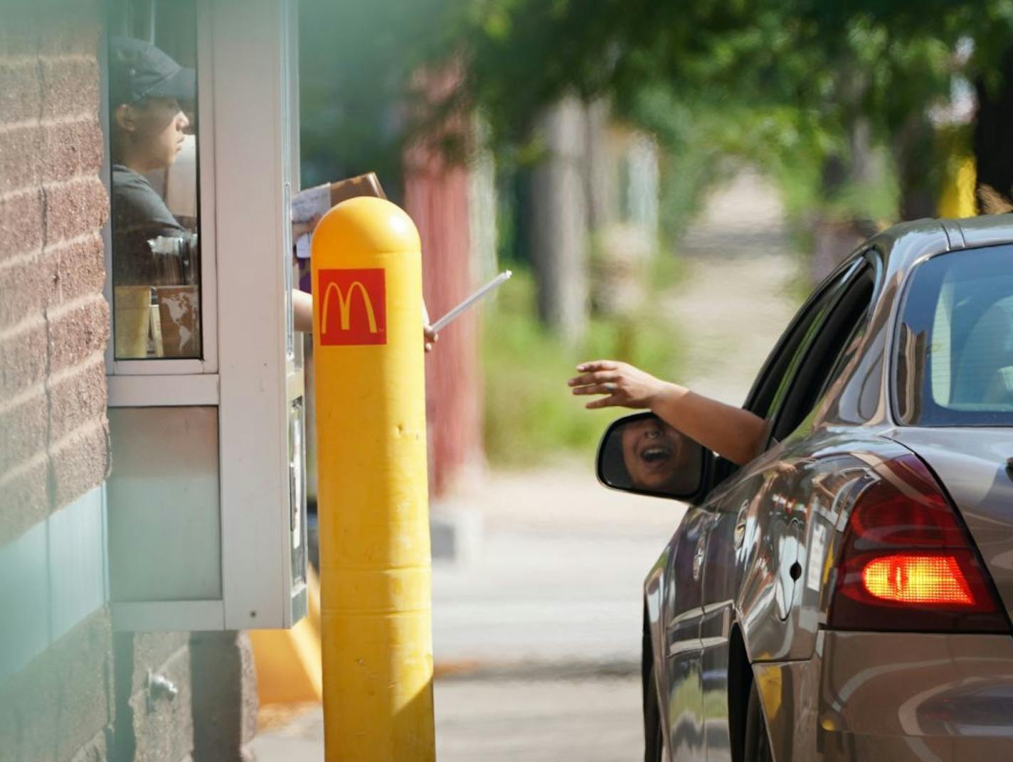 Cars idle while sitting in the drive-thru lane at McDonald's on Broadway in North Minneapolis.