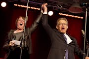 Sen. Amy Klobuchar (D-MN) and Sen. Al Franken (D-MN) celebrate onstage during Minneapolis Mayor Betsy Hodges' inauguration party at the historic Thorp
