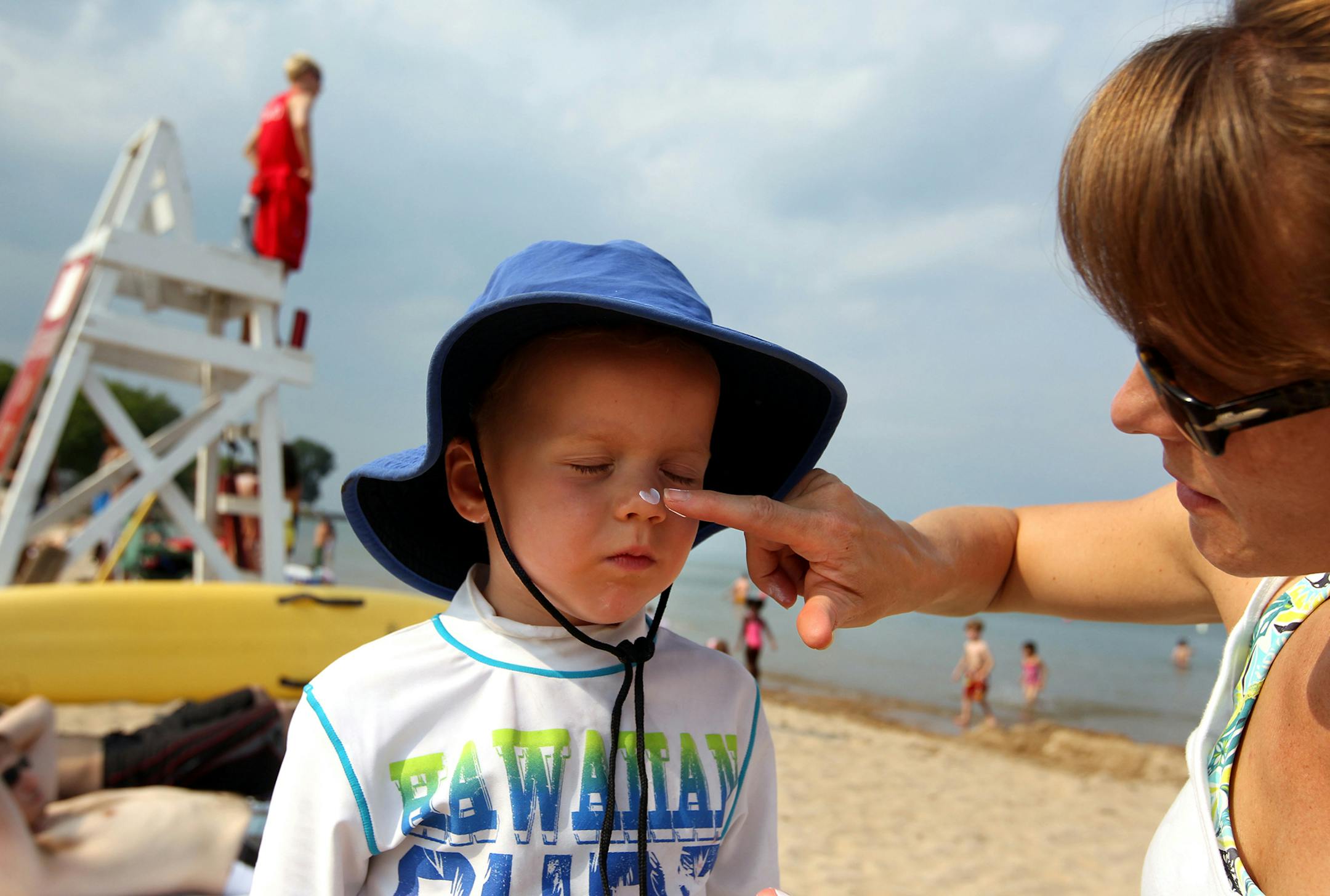 Kristin Conn puts sunscreen on her son, Merrick, at Lee Street Beach in Evanston, Illinois, on June 28, 2012. (Chris Sweda/Chicago Tribune/MCT) ORG XMIT: 1126077