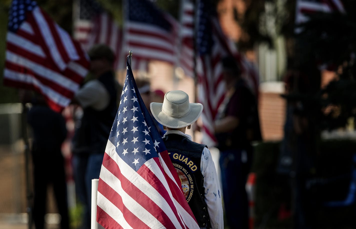 A Patriot Guard Rider stands at the entrance of the Wayzata Free Church before the start of police officer William Mathews' funeral Thursday.