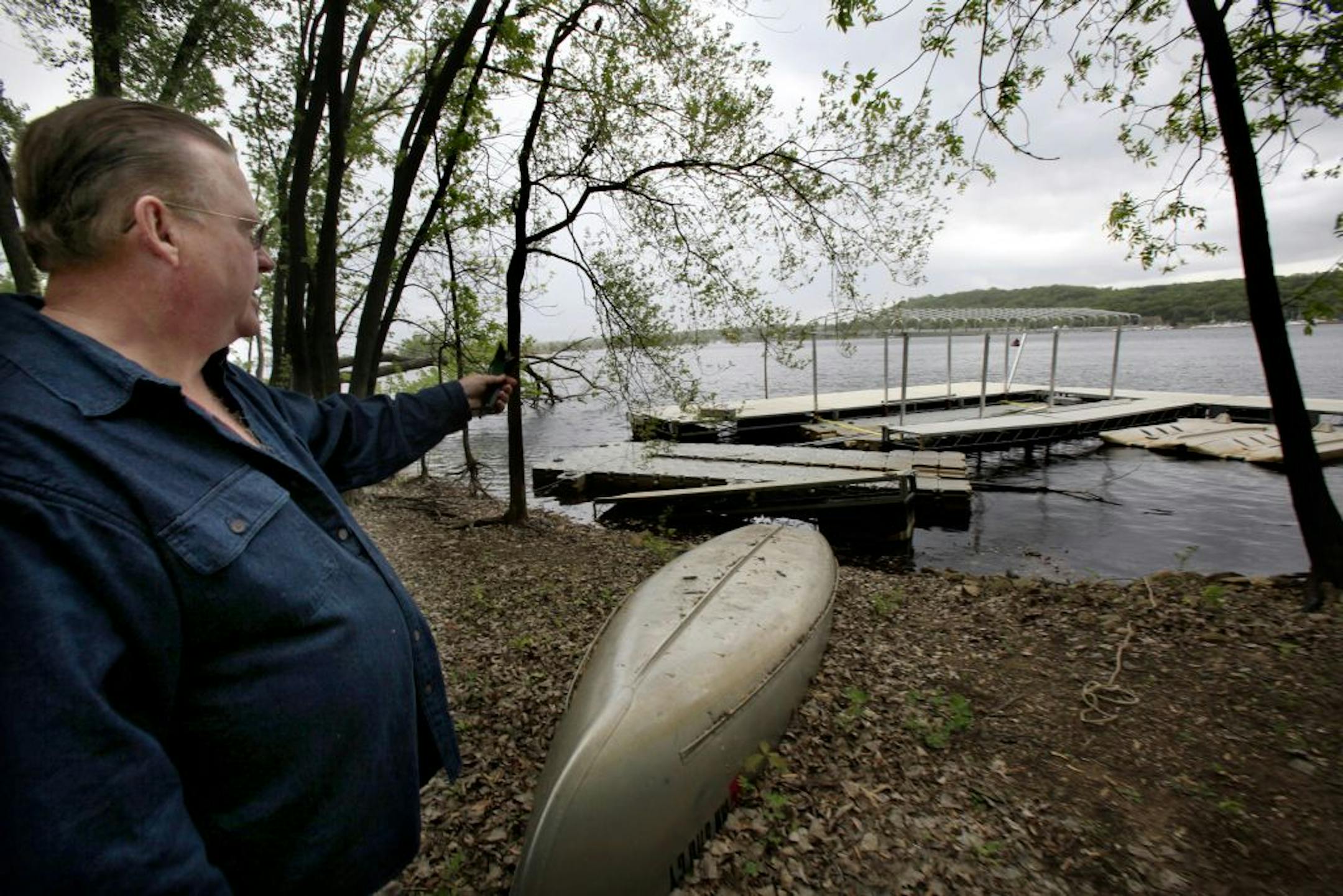 James Space points to his docks that are not in place because he has just returned from Florida but the city claims he is using the area for a marina on his Lakeland home property. May 8, 2012.