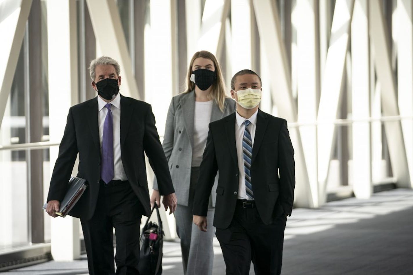 Former Minneapolis police officer Tou Thao, right, arrives with his lawyer Robert Paule, left, for a hearing at the Hennepin County Government Center in July.