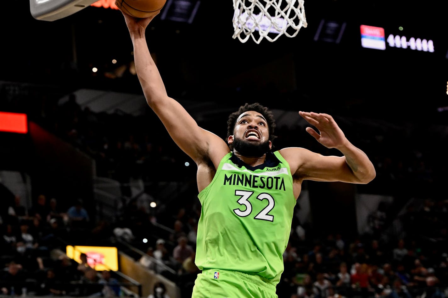 Minnesota Timberwolves' Karl-Anthony Towns dunks during the first half of an NBA basketball game against the San Antonio Spurs on Monday, March 14, 2022, in San Antonio. (AP Photo/Darren Abate)