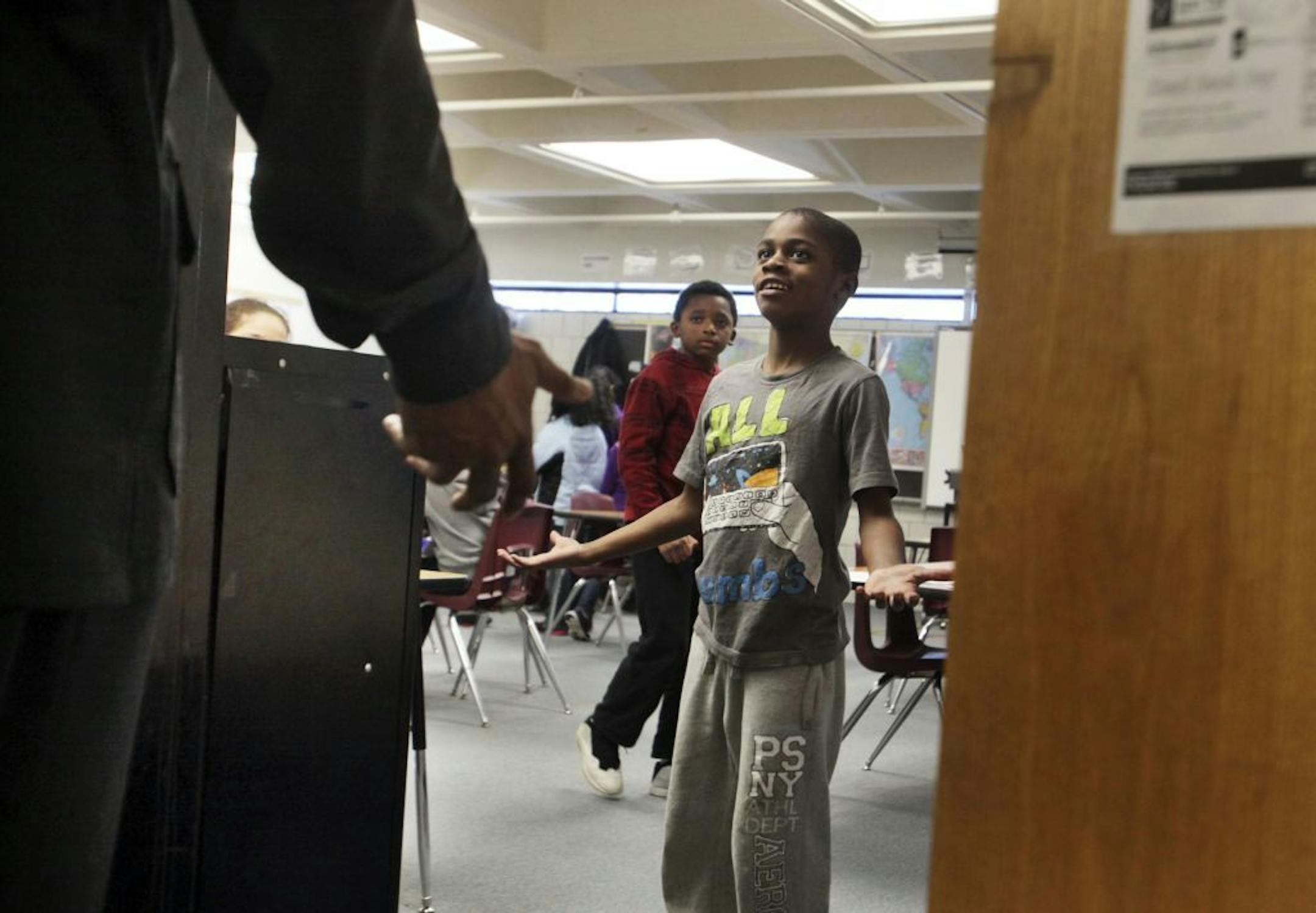 While making his rounds at Daytons Bluff Elementary School staff member Gary Trent reminds a student that the school is not a place to dance in the hallway Wednesday, Feb. 6, 2013, in St. Paul, MN.