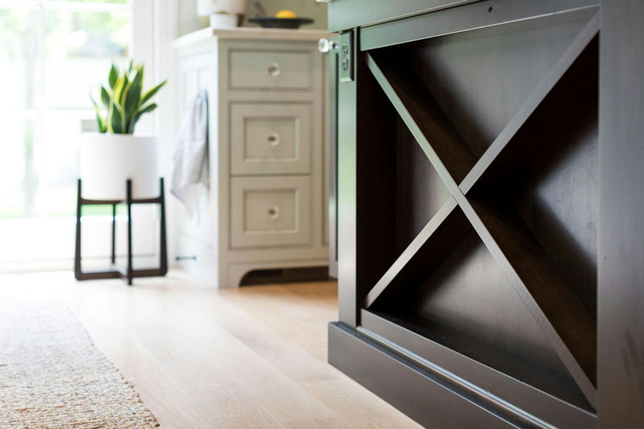 Dark island in kitchen designed by Renae Keller