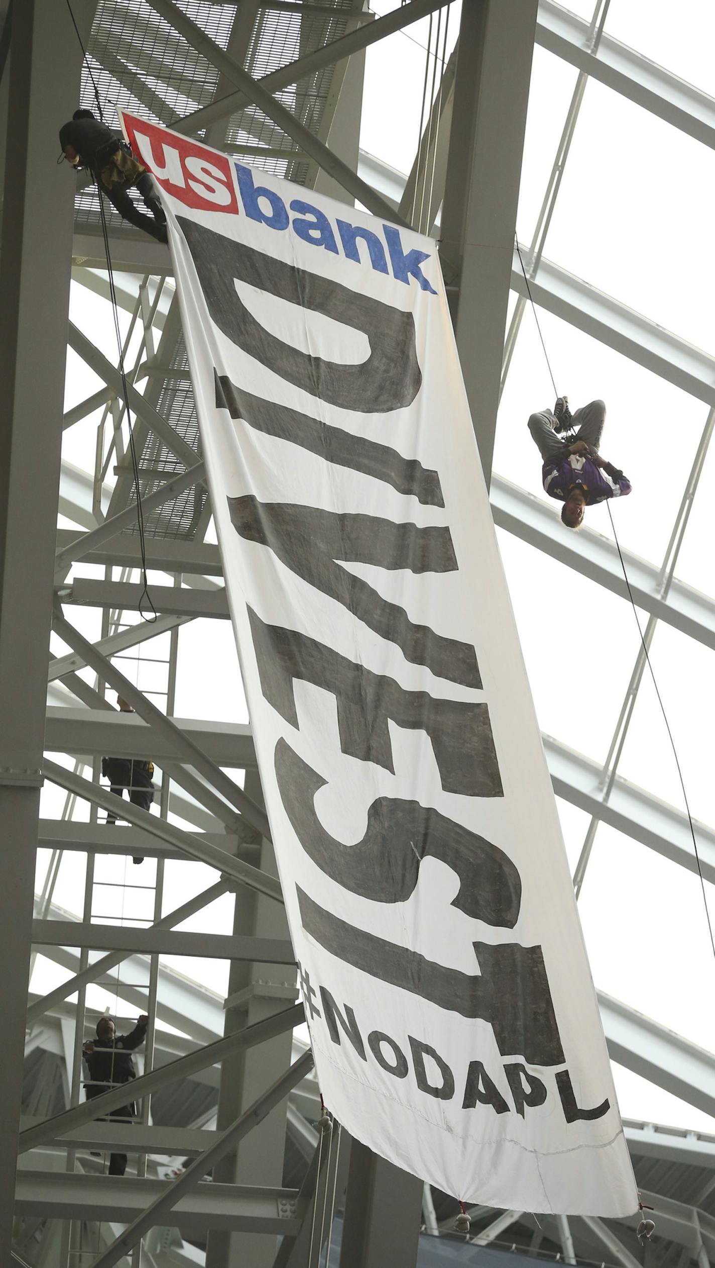 Protestors hung a banner from the catwalk of U.S. Bank Stadium calling for U.S. Bank to divest it's interests in the controversial pipeline in the Dakotas. ] JEFF WHEELER &#xef; jeff.wheeler@startribune.com The MInnesota Vikings faced the Chicago Bears in their final game of the NFL season Sunday afternoon, January 1, 2017 at U.S. Bank Stadium in Minneapolis.