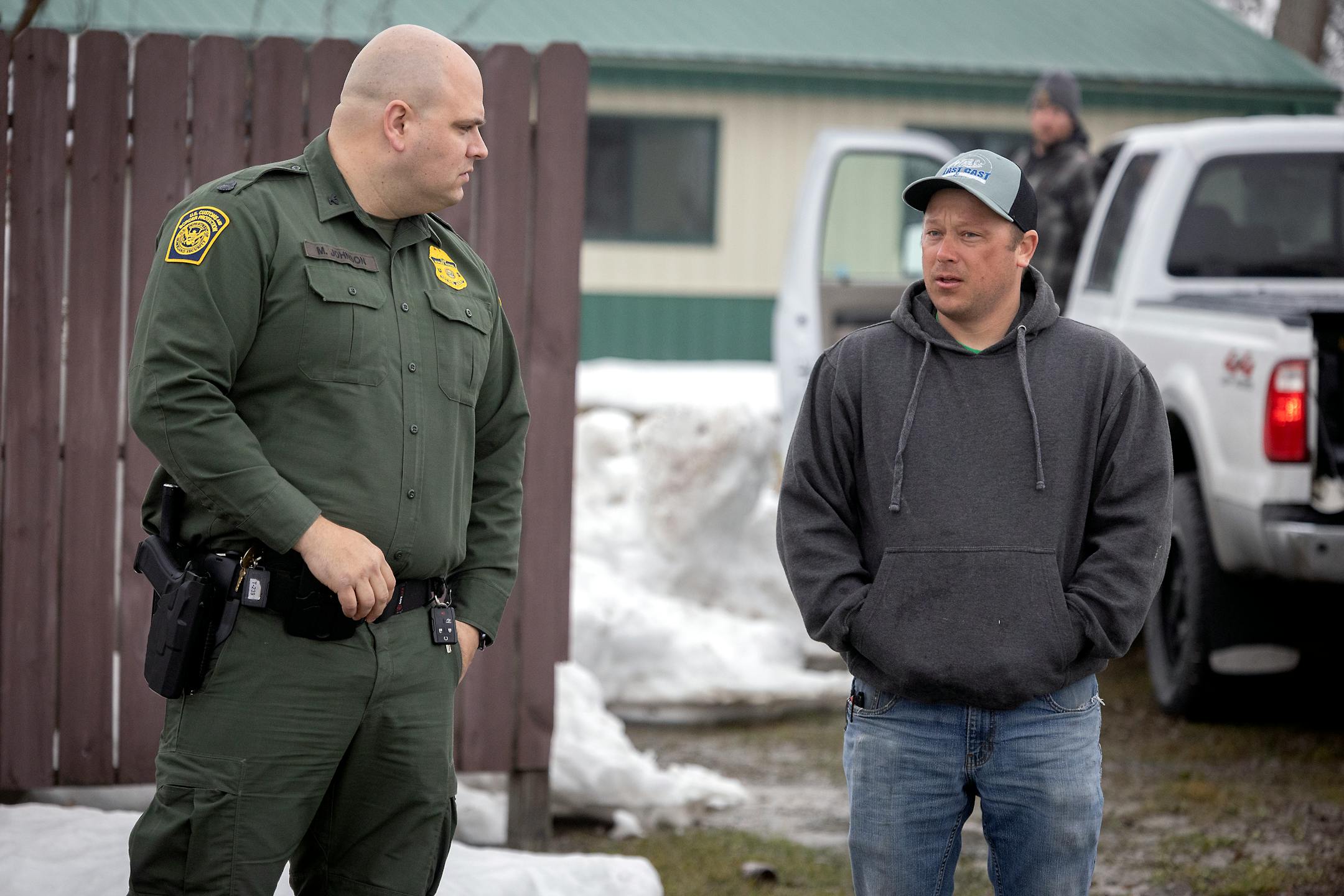 Mike Johnson, patrol agent in charge of the Warroad border patrol station, talks to fishermen fishing on Lake of the Woods in Warroad, Minn., on Tuesday, March 22, 2022. Johnson said he likes to keep an open dialogue with residents and visitors who fish on the lake.