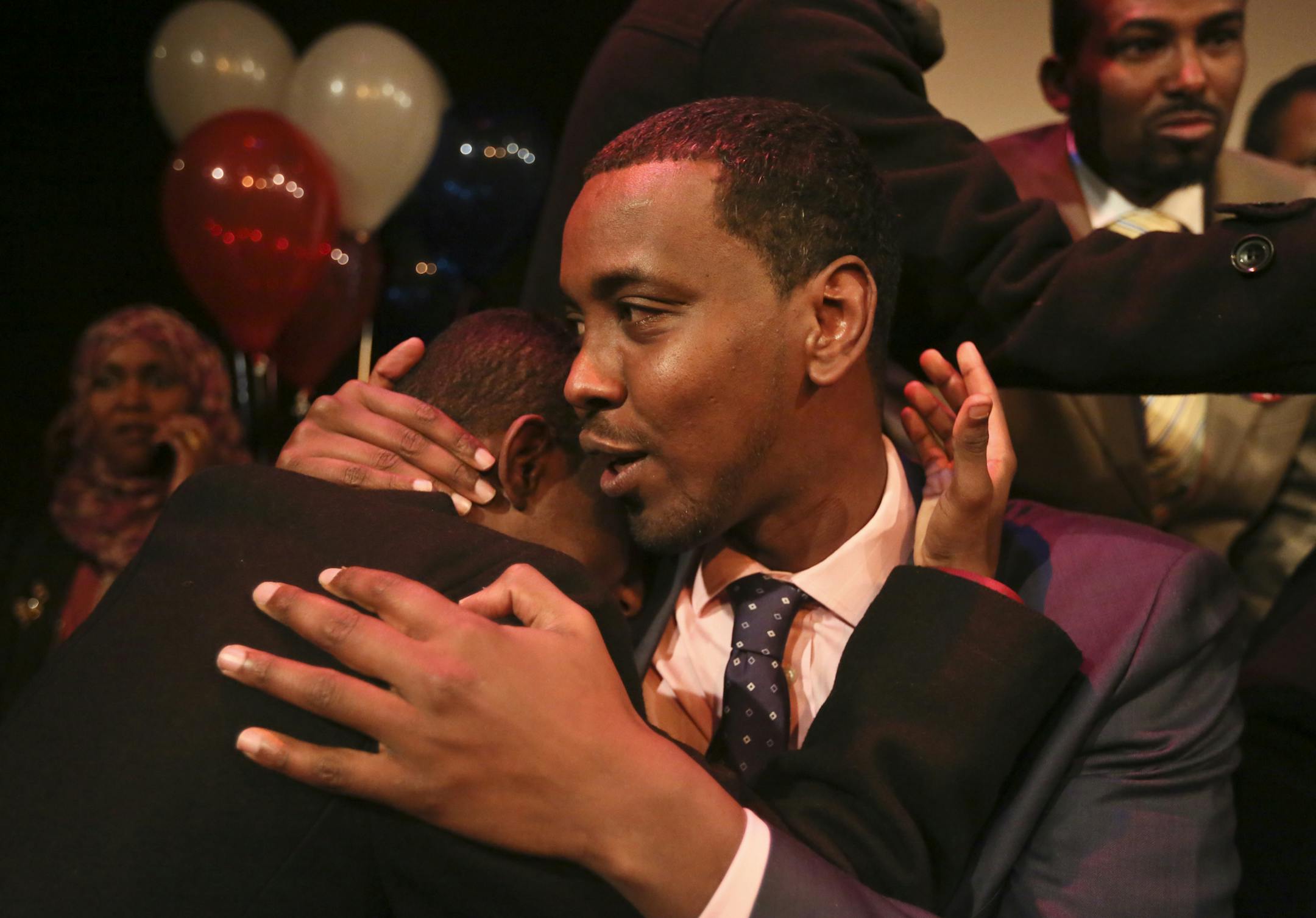 After his landslide victory, Ward 6 City Council candidate Abdi Warsame gets a hug from volunteer Ali Saleh Tuesday, Nov. 5, 2013, in Minneapolis, MN at the victory party at Mixed Blood Theatre.