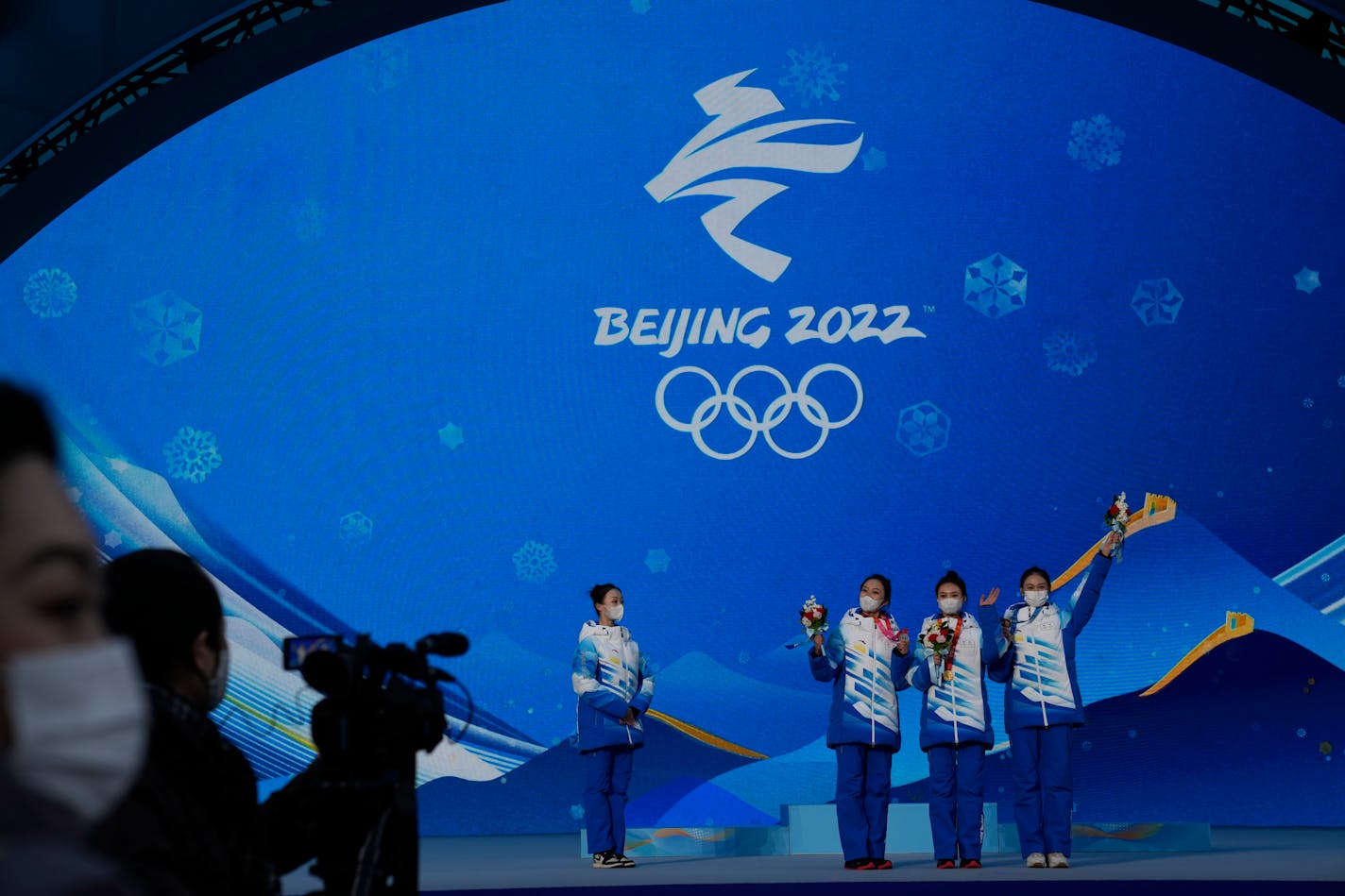 Staff members rehearse a victory ceremony at the Beijing Medals Plaza of the Winter Olympics in Beijing, China, Monday, Jan. 3, 2022. (AP Photo/Ng Han Guan)