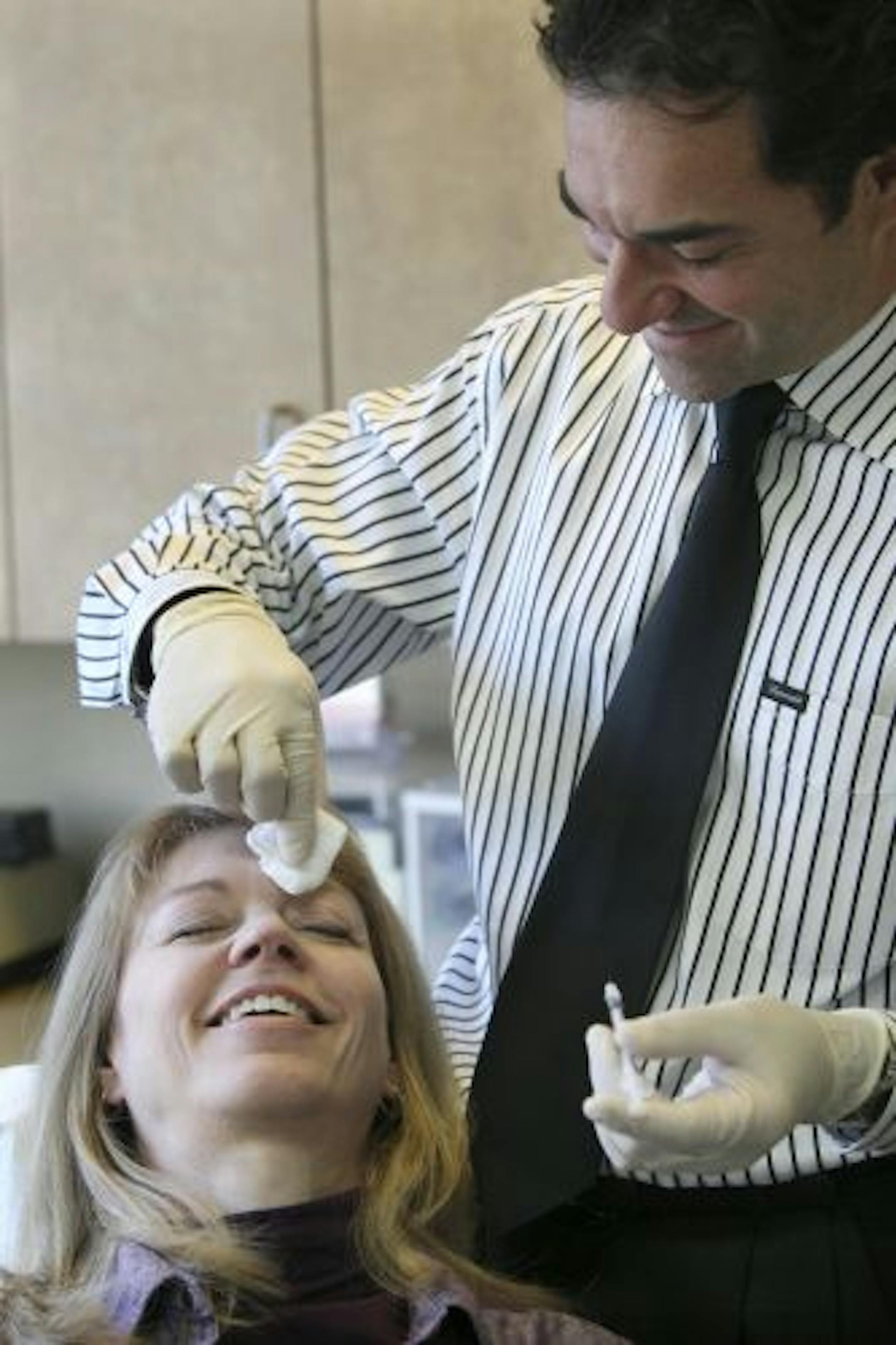 Dr. Michael Skadron of West River Dental Care injected botox into Pat Grubbe, one of Skadron's dental hygienists.
