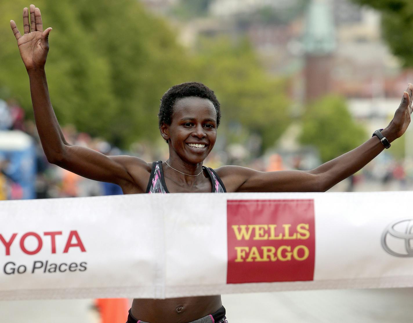 t06.20.2015 -- Steve Kuchera -- kucheraGMA0621c11 -- Jane Kibii smiles as she nears the tape in the Grandma's Marathon Saturday. Kibii won the women's race with a time of 2:32:06. Steve Kuchera / skuchera@duluthnews.com