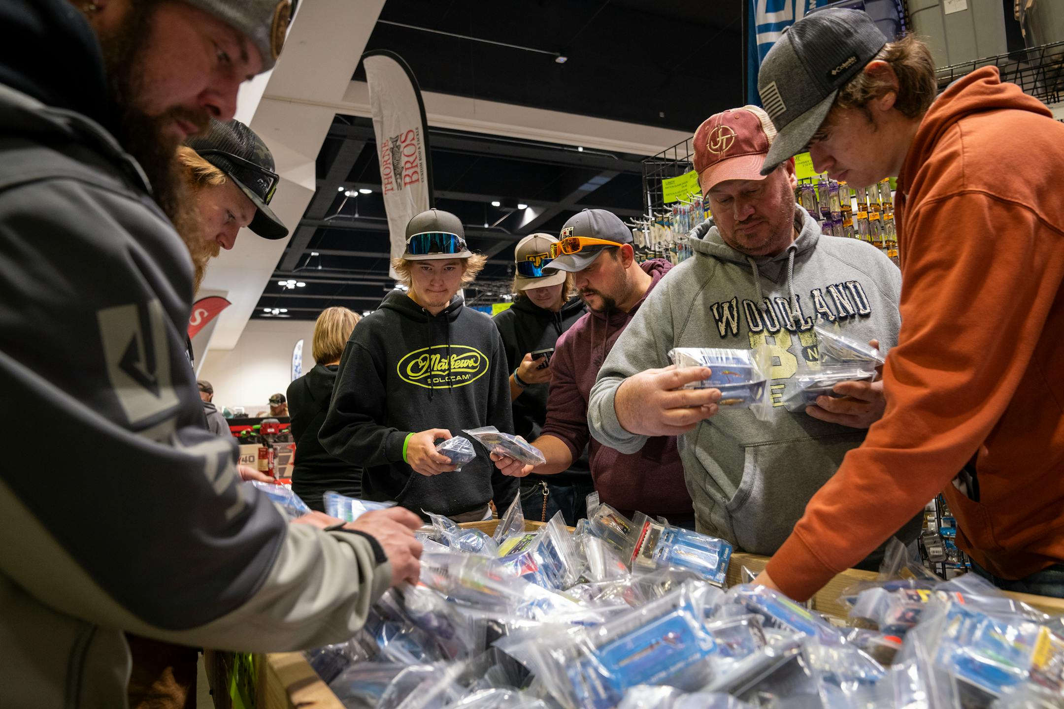 Customers grab up good deals on lures and baits at Thorne Bros Custom Rod &amp; Tackle at the St. Paul Ice Fishing and Winter Sports Show in St. Paul, Minn. Friday, Dec. 1, 2023. ] LEILA NAVIDI • leila.navidi@startribune.com