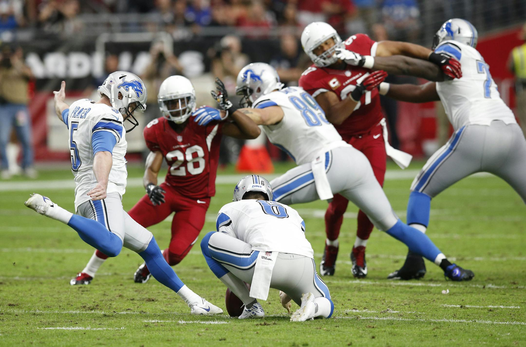 Detroit Lions kicker Matt Prater kicks a field goal against the Arizona Cardinals as Sam Martin (6) holds during the first half of an NFL football game, Sunday, Nov. 16, 2014, in Glendale, Ariz. (AP Photo/Ross D. Franklin)