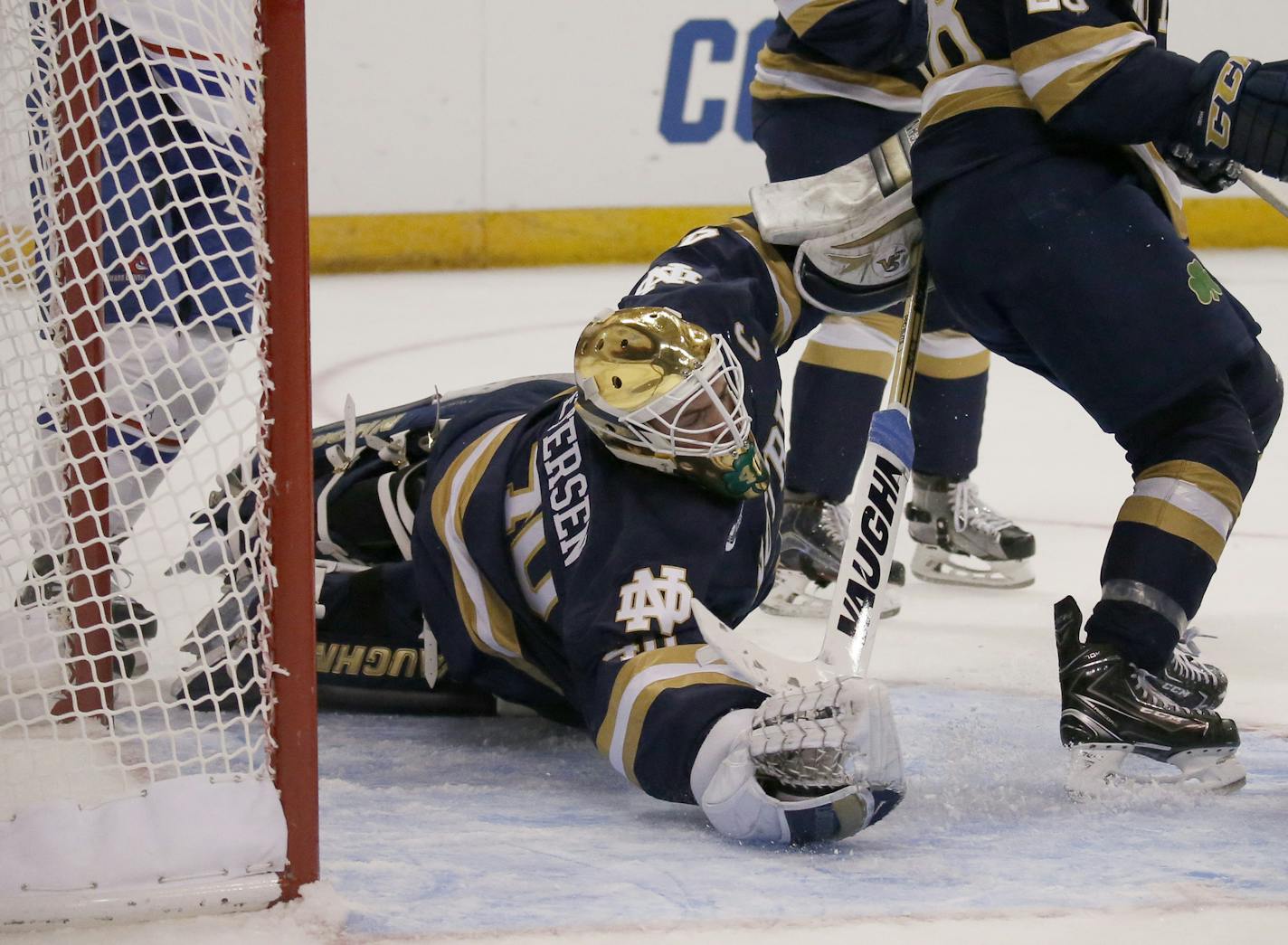 Notre Dame goalie Cal Petersen dives across the crease to make a save against UMass Lowell during the first period of an NCAA regional men's college hockey tournament game, Sunday, March 26, 2017 in Manchester, N.H. (AP Photo/Mary Schwalm)