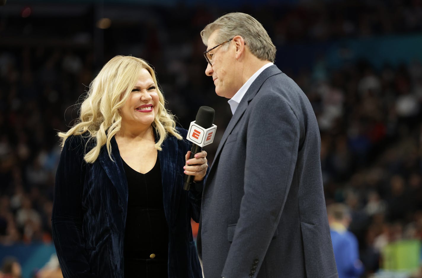 ESPN's Holly Rowe interviews UConn coach Geno Auriemma Friday at Target Center.