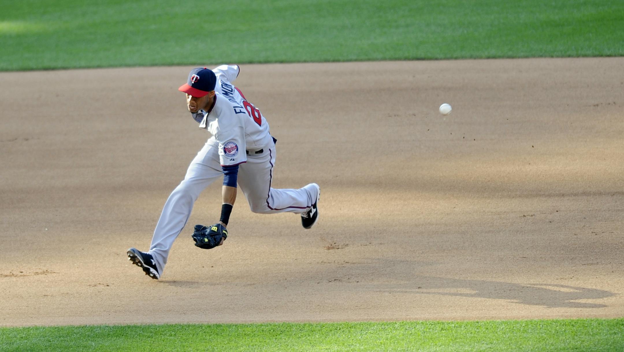 A ball hit by Washington Nationals' Kurt Suzuki for a double gets past Minnesota Twins shortstop Pedro Florimon during the seventh inning of an interleague baseball game, Saturday, June 8, 2013, in Washington. The Twins won 4-3 in 11 innings. (AP Photo/Nick Wass)