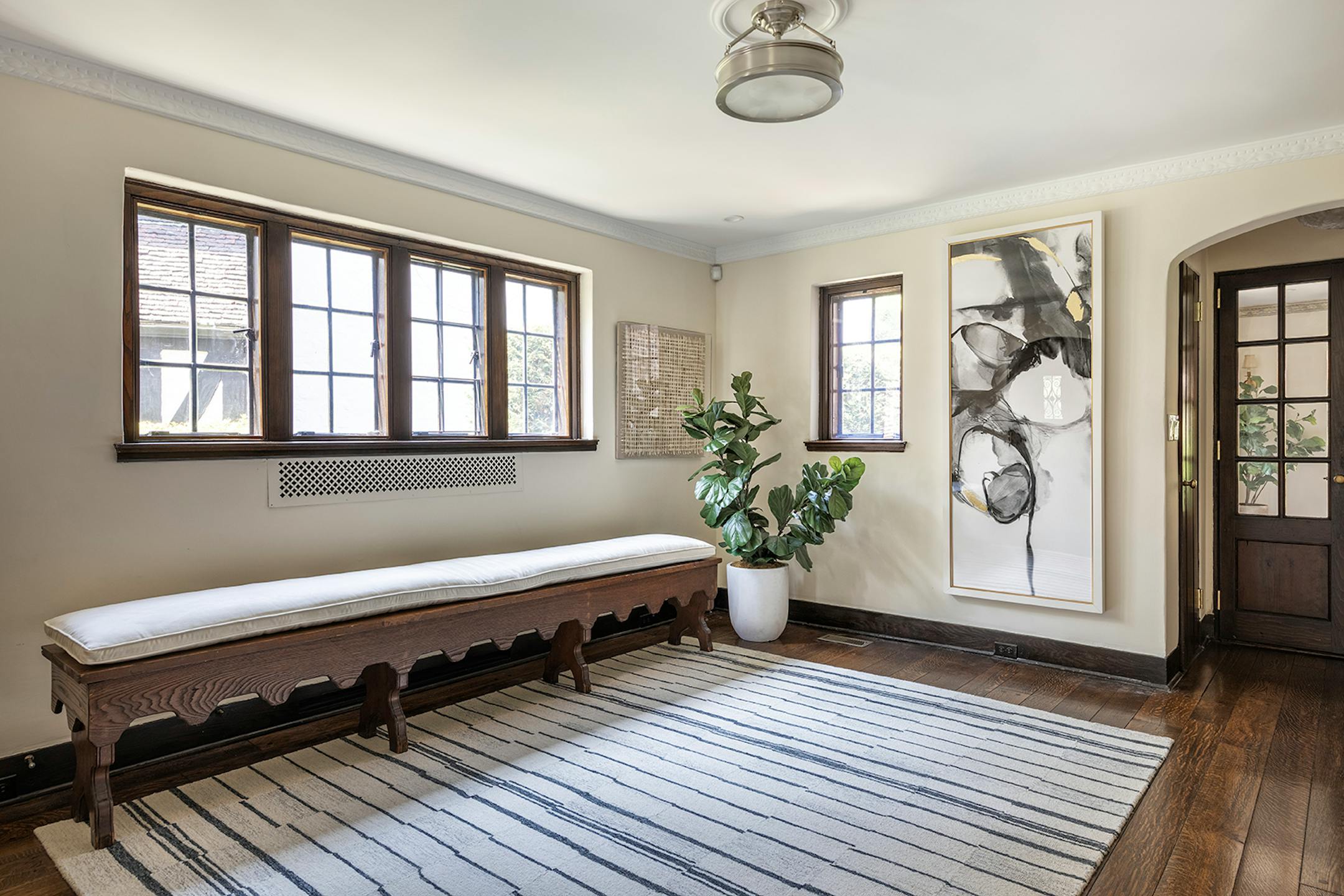 A hand crafted bench adds an element of grandeur to this home entry. (Handout/TNS)