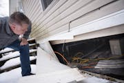 Dean Swenson showed the piping under a home in the Viking Terrace Mobile Home Park he and several other community members helped winterize with heat t