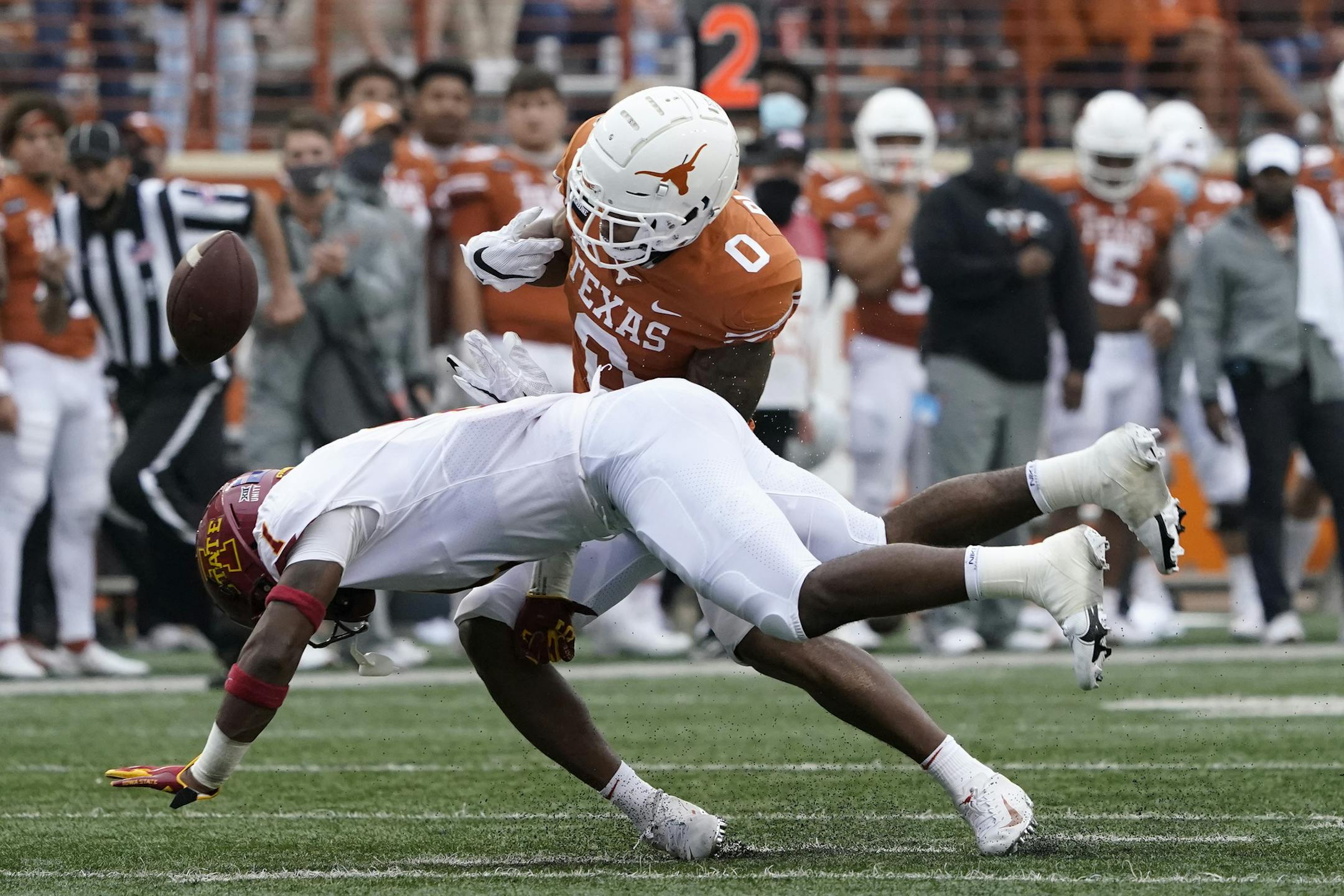 Iowa State defensive back Isheem Young (1) causes Texas wide receiver Tarik Black (0) to fumble the ball during the first half of an NCAA college football game, Friday, Nov. 27, 2020, in Austin, Texas. Iowa State recovered the ball. (AP Photo/Eric Gay)
